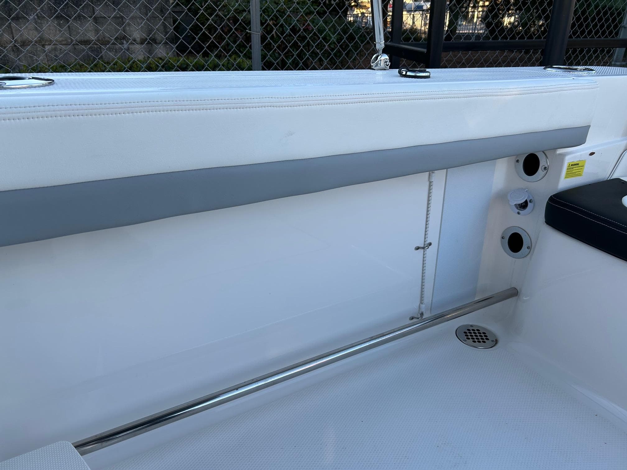2026 Robalo R207 Dual Console interior with white seating and stainless steel accents.