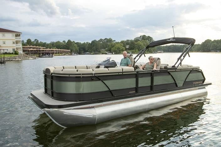 2026 Veranda Relax VR235RCP pontoon boat on a serene lake with two passengers.