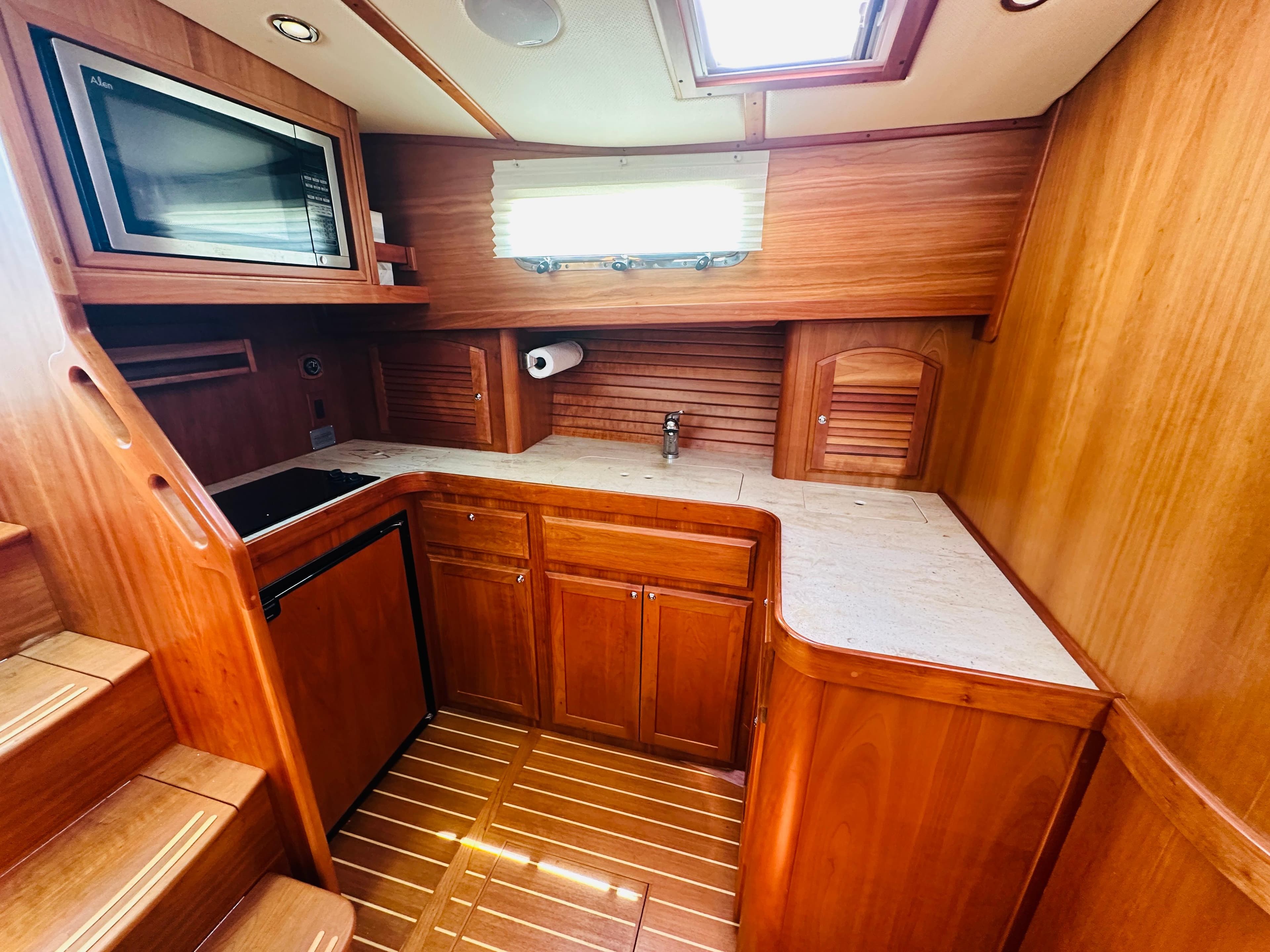 2008 Sabre 42 Hardtop Express galley with wood cabinetry and modern appliances.