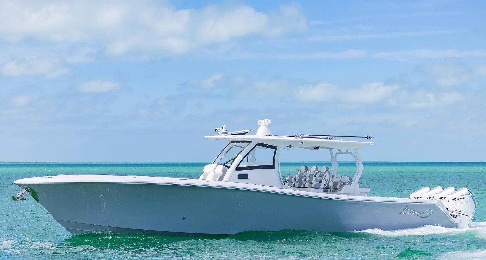 2025 Blackwater 43 Sportfish boat cruising on turquoise ocean waters under a clear sky.