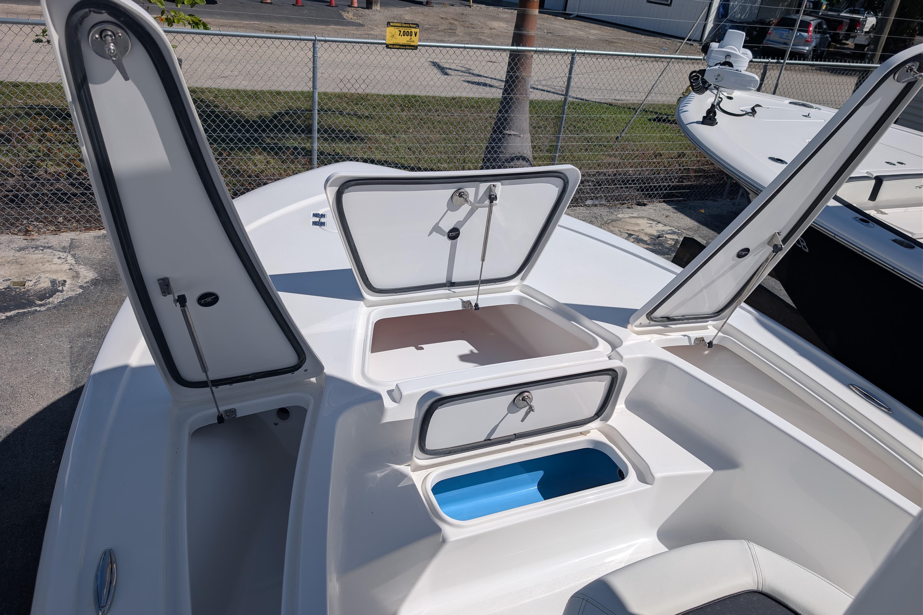 2026 Tidewater 2110 Bay Max boat with open storage compartments on deck.