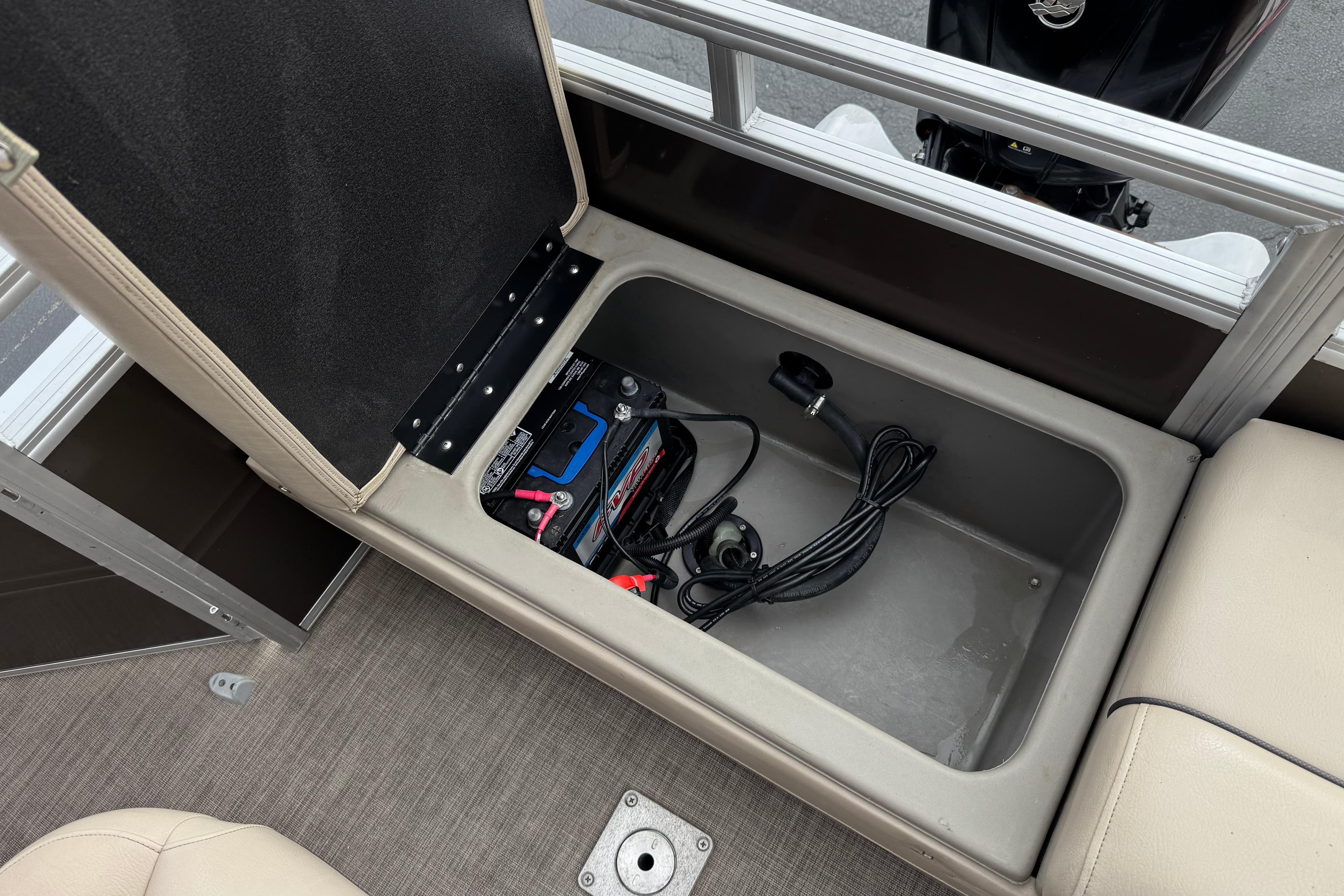 2024 Sun Tracker SportFish 22 DLX storage compartment with battery and cables.