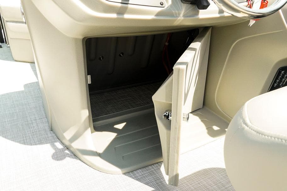 Open storage compartment on 2026 Dockside Pontoons 22DQ boat console.