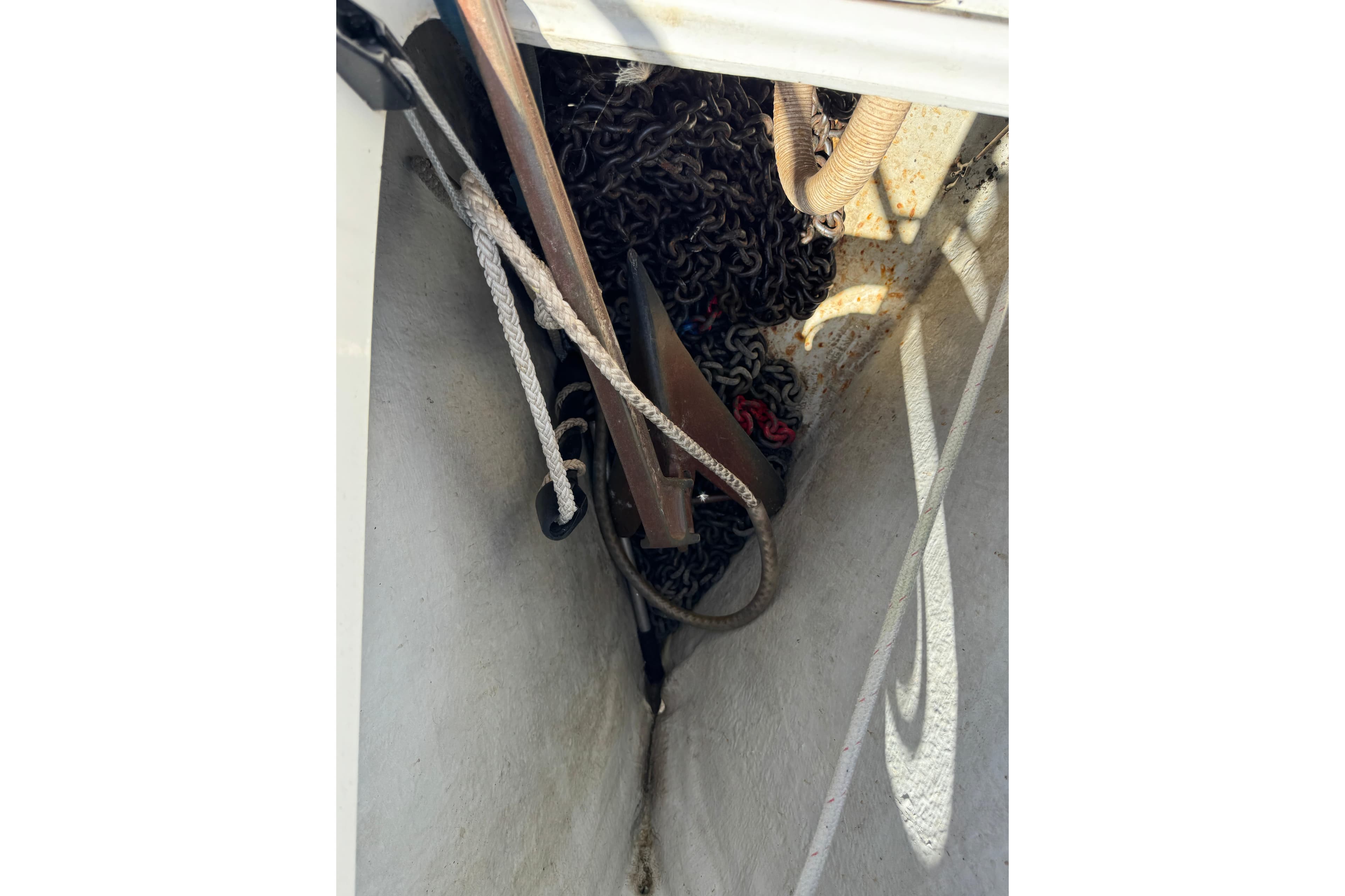 Anchor chain and ropes in the storage compartment of a 1996 Beneteau First 42s7 sailboat.