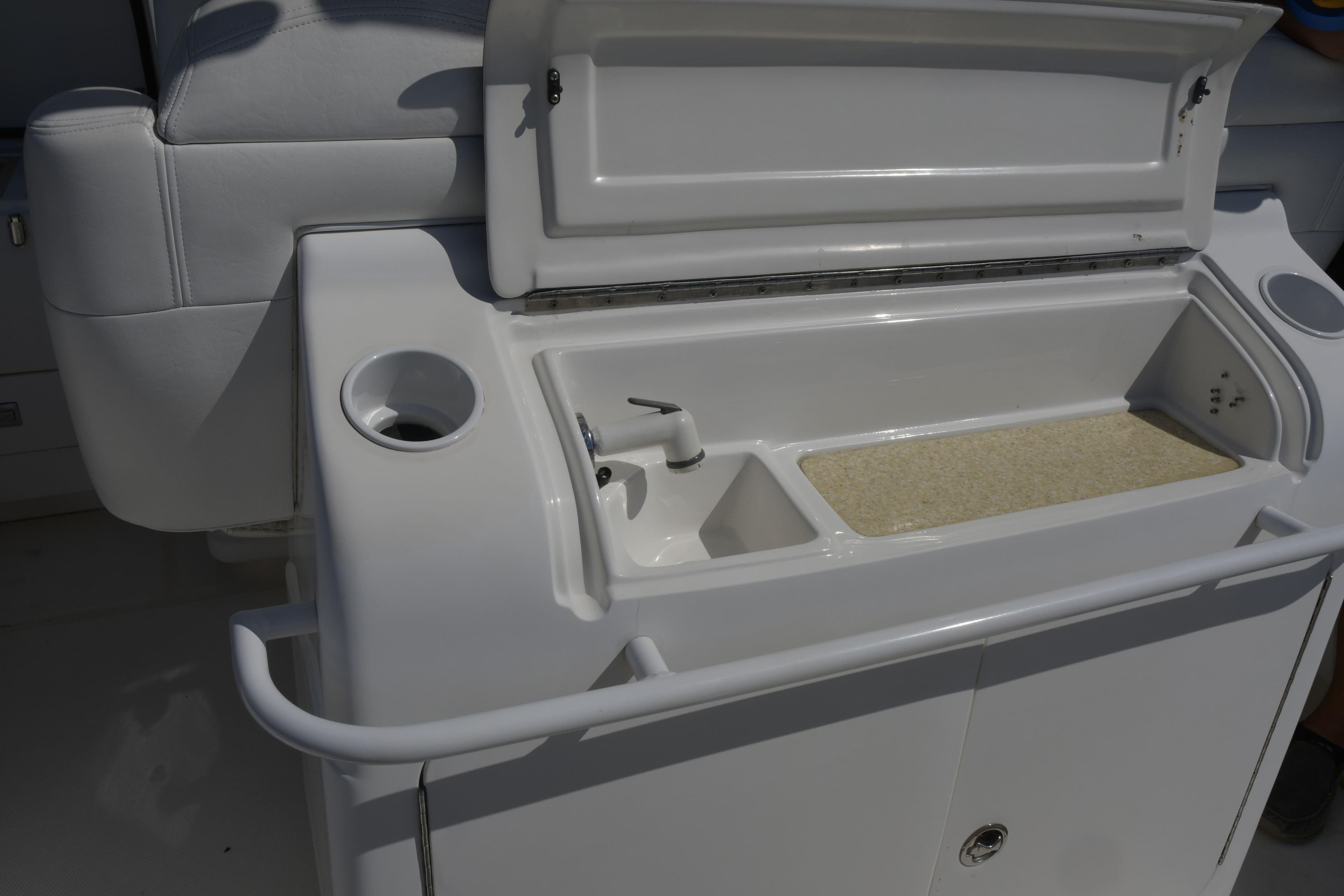 2010 Deep Impact 36 TE boat sink and storage area with open lid.