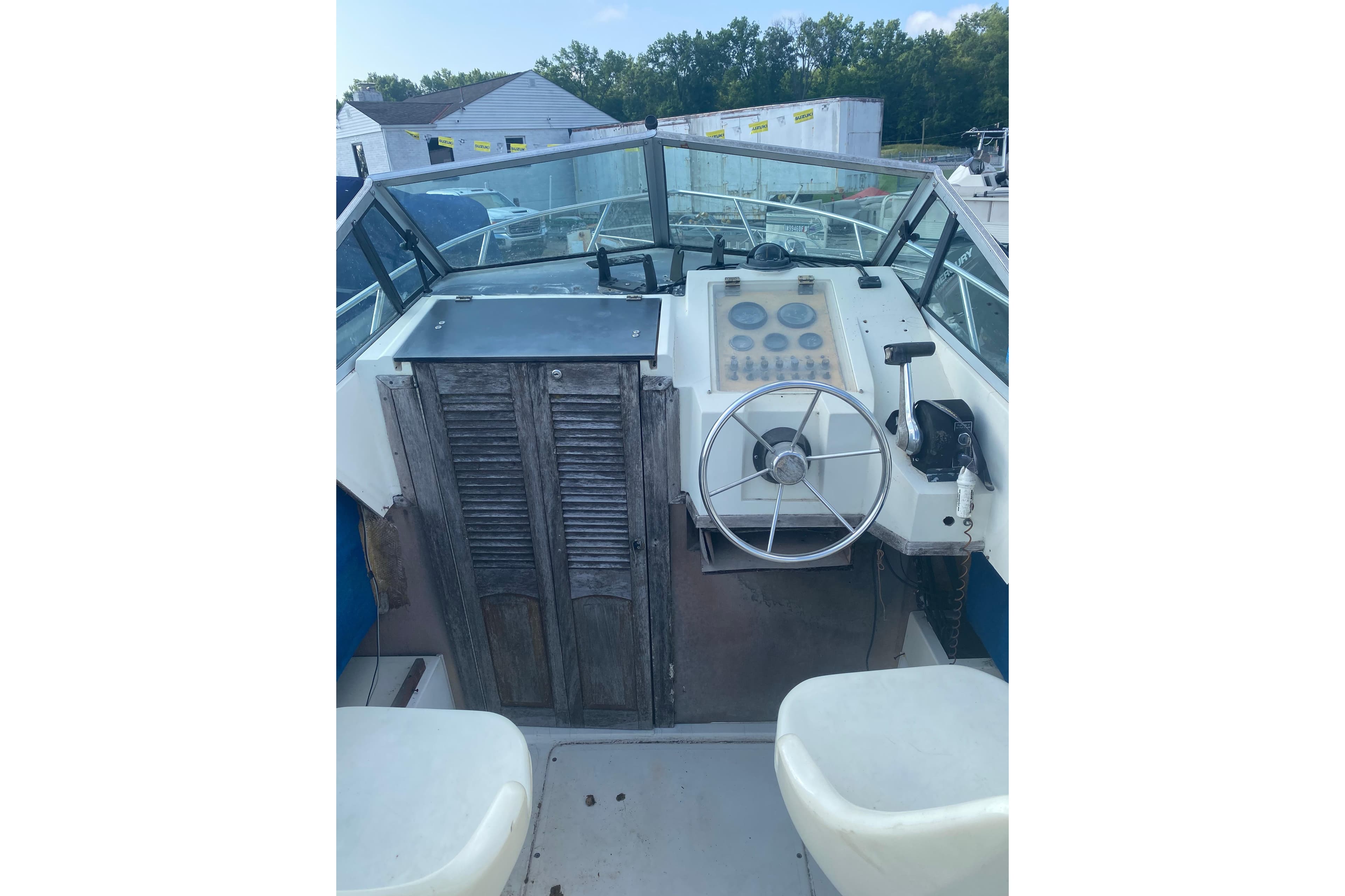 1984 Hydra-Sports 2250 WA boat cockpit with steering wheel and control panel.