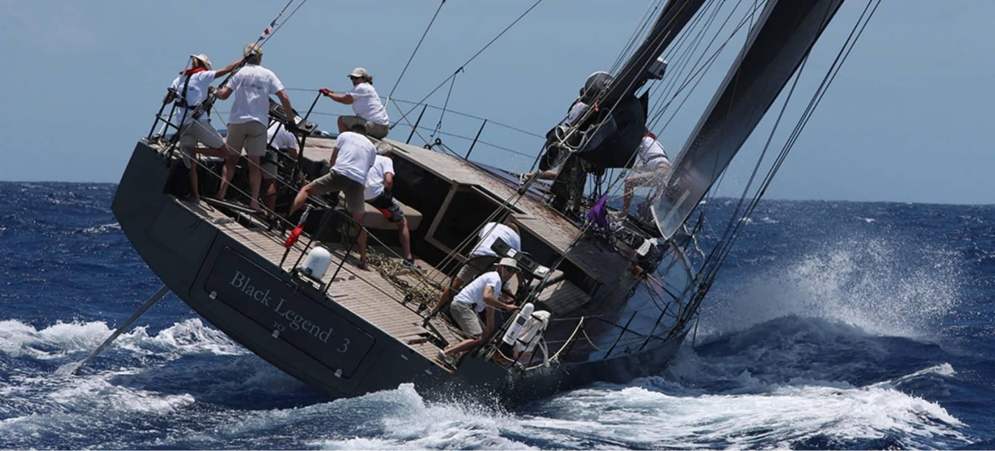 Sailboat racing on rough seas, crew in action, Black Pepper Code 2, 2025 model.