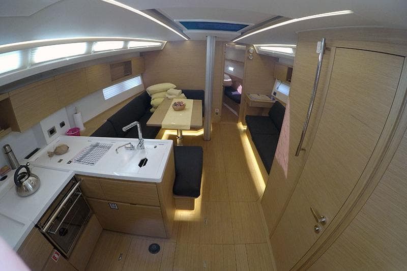 Luxurious interior of 2023 Grand Soleil 44 Performance yacht with modern kitchen and seating area.