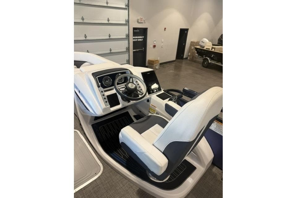 2024 Barletta Corsa 21UC boat cockpit with steering wheel and control panel.