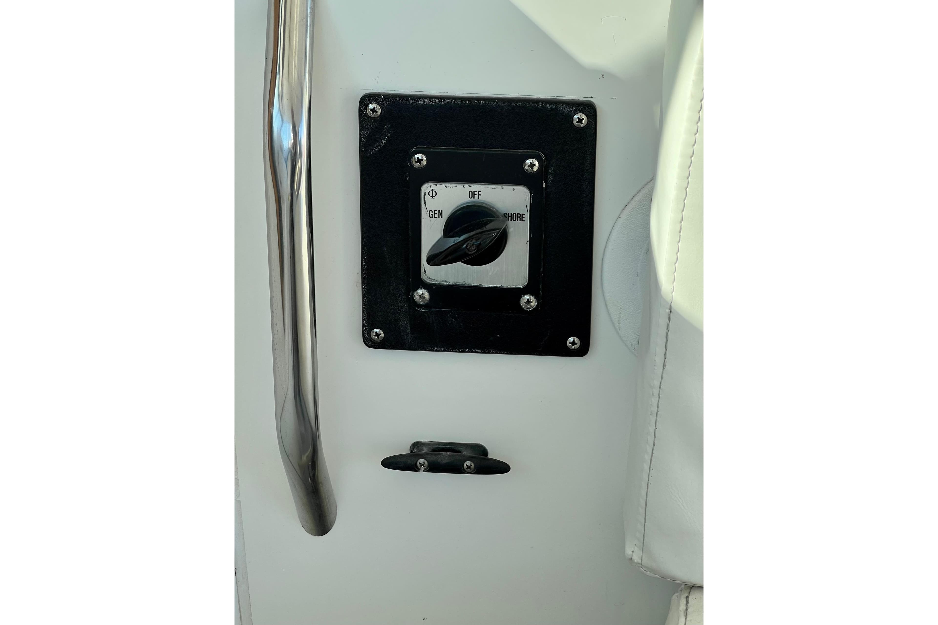 Control panel on a 1998 Baha Cruisers 340 CAT boat, featuring a switch and handle.