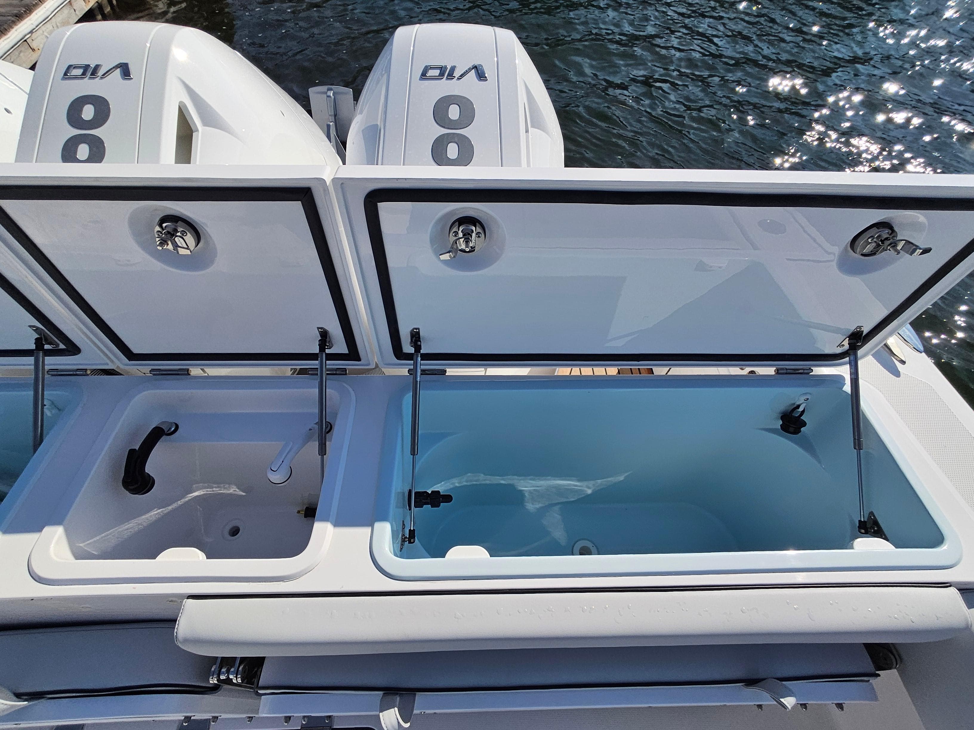 2025 Southport 38 FE boat with open storage compartments and dual engines.