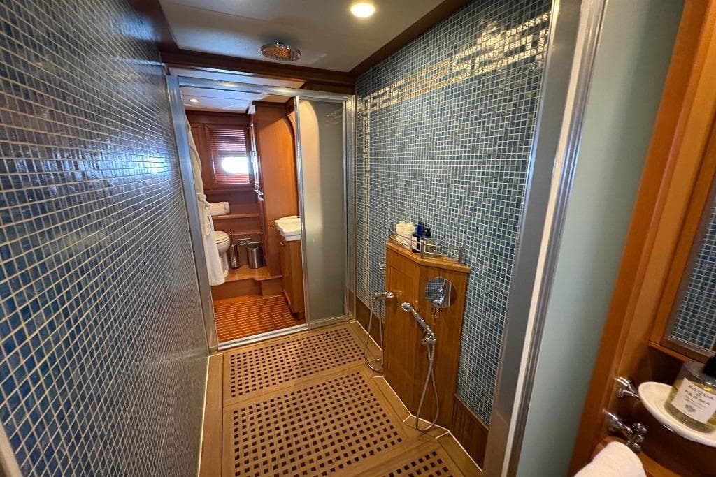 Luxurious bathroom on 2006 Mochi Craft 74' Dolphin yacht with elegant wood and tile design.