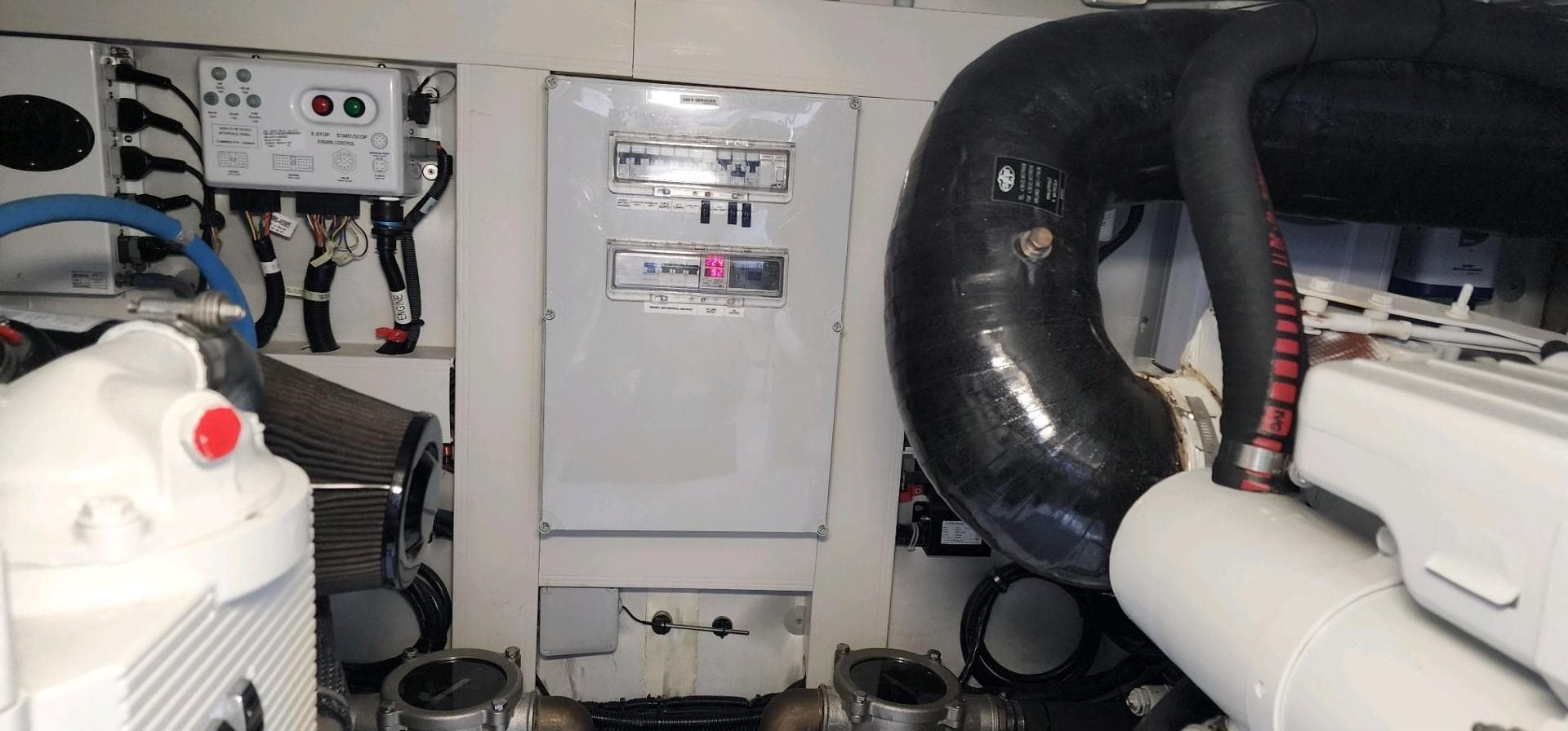 Engine room of 2013 Azimut 45 Flybridge yacht, showcasing mechanical components and control panel.