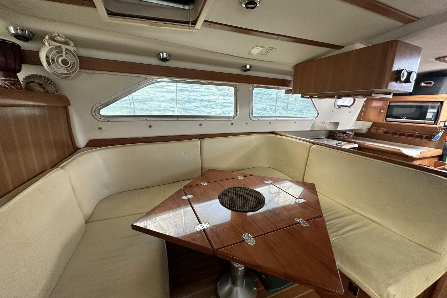 Interior of 2008 Catalina Morgan 440 yacht with cozy seating and wooden table.