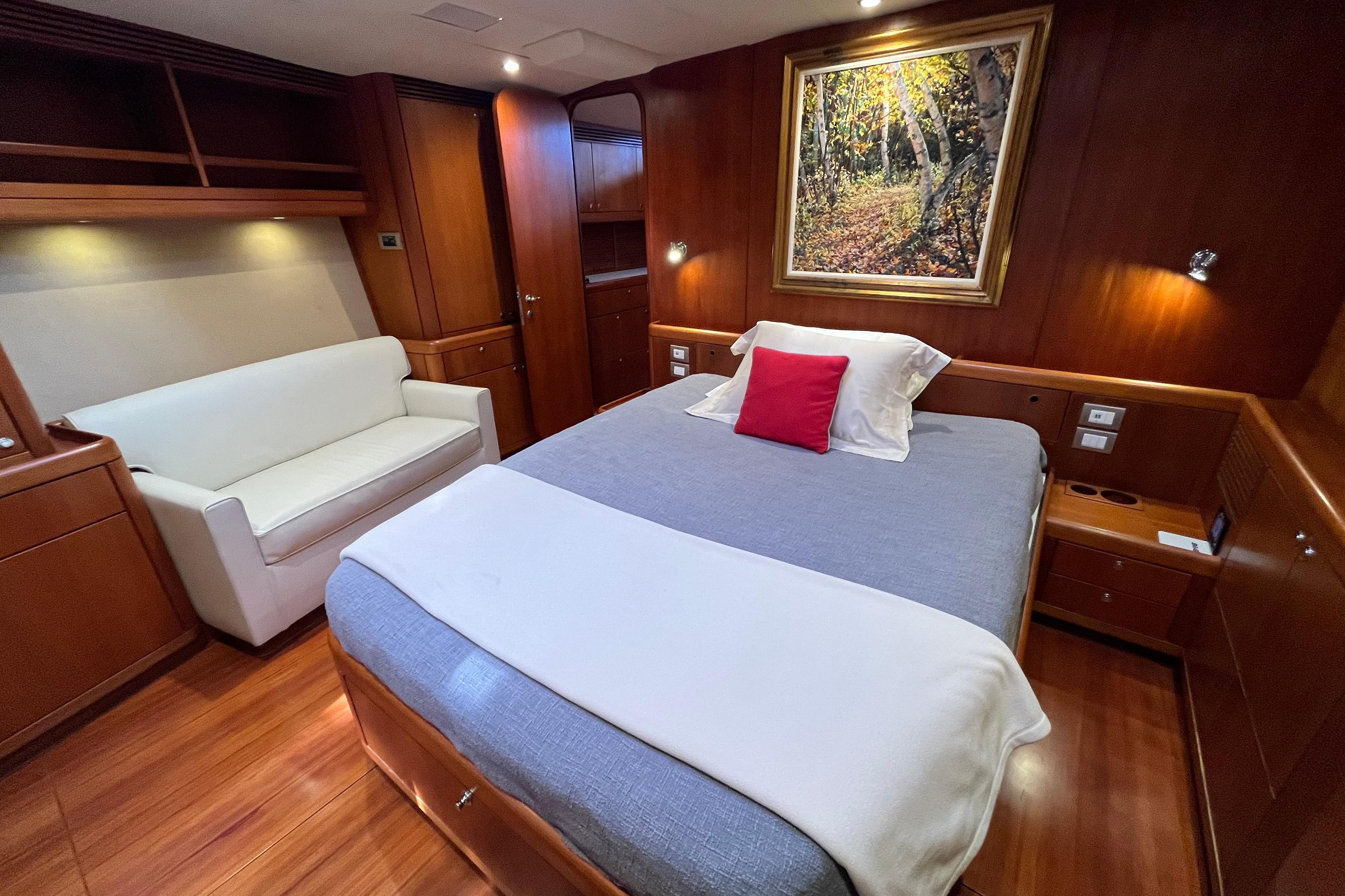 Luxurious cabin interior of 2003 Southern Wind SW80 yacht with cozy bed and elegant decor.