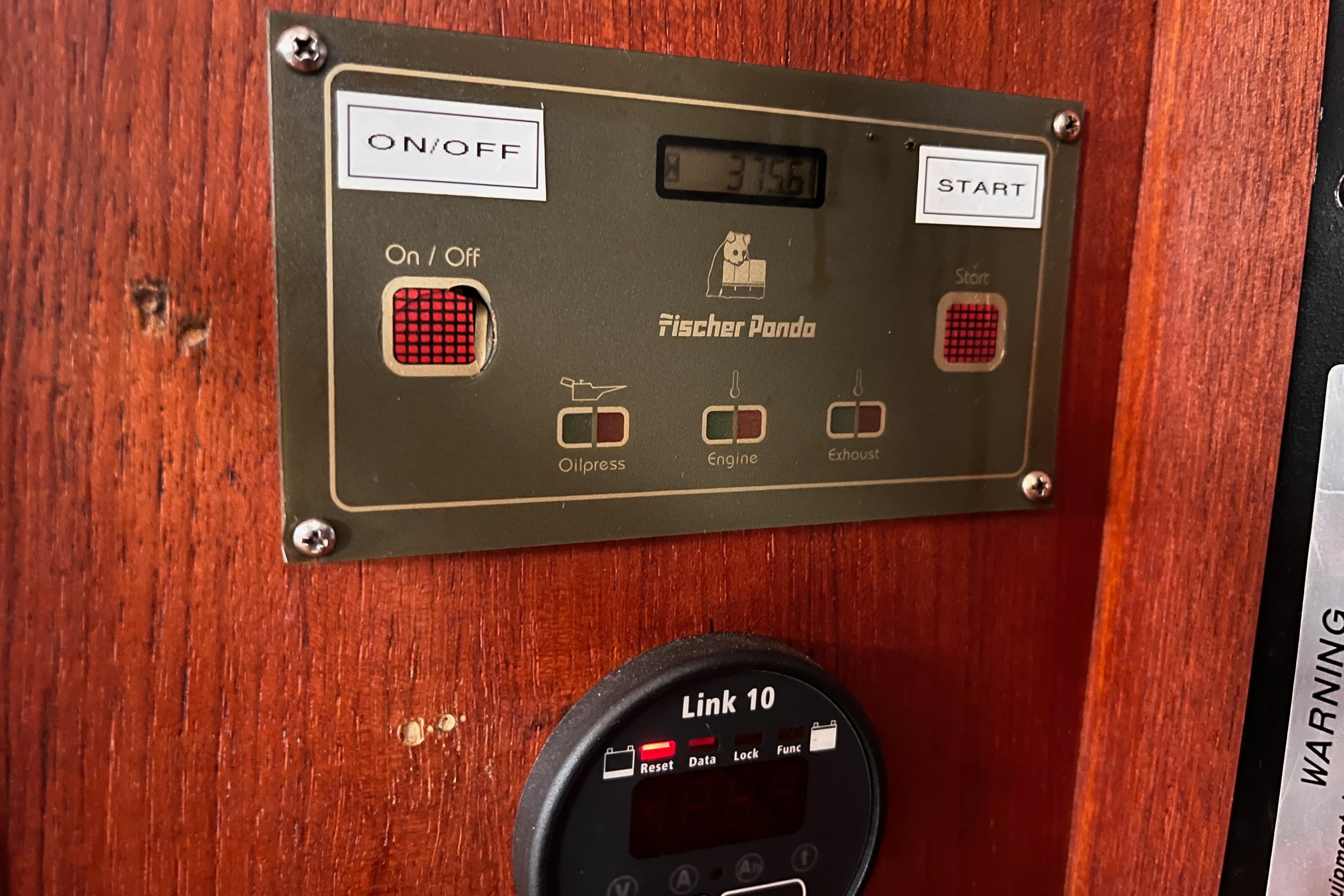 Fischer Panda control panel on 2000 Island Packet 350 sailboat, featuring on/off and start buttons.