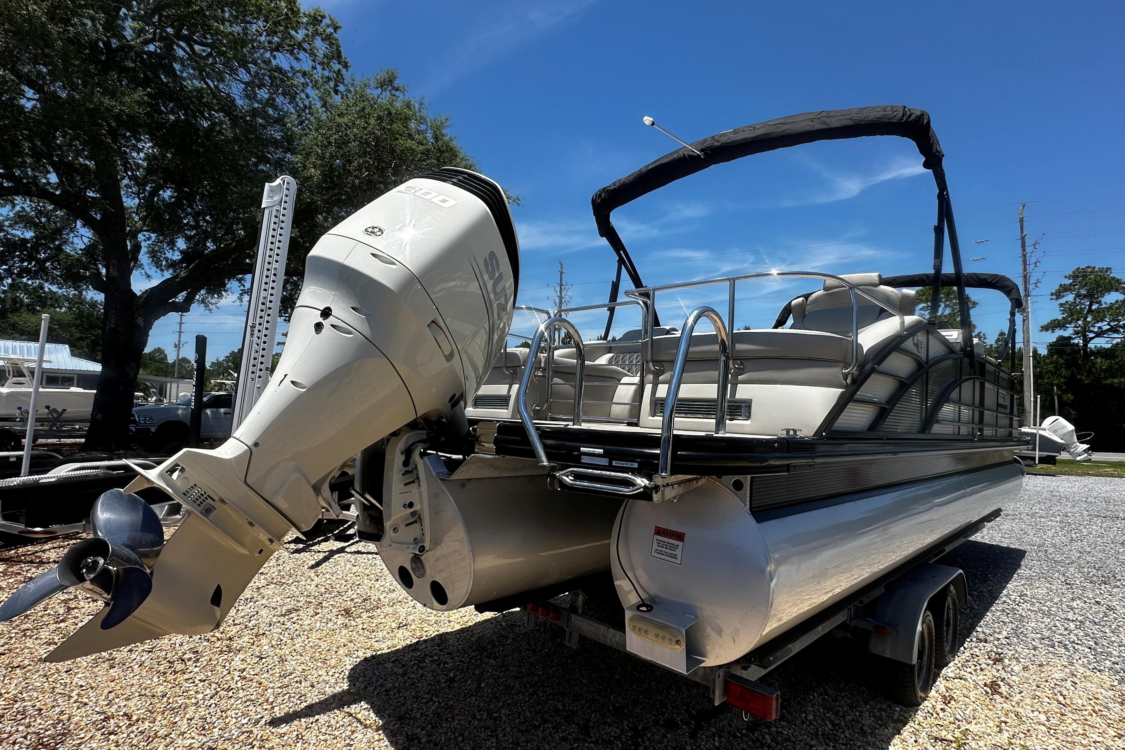 2019 Bennington QX 25 Stern Lounge pontoon boat with powerful outboard motor on trailer.