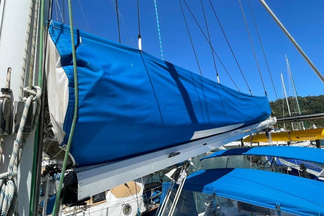 1981 Corbin 39 sailboat with blue sail cover, docked in a marina.