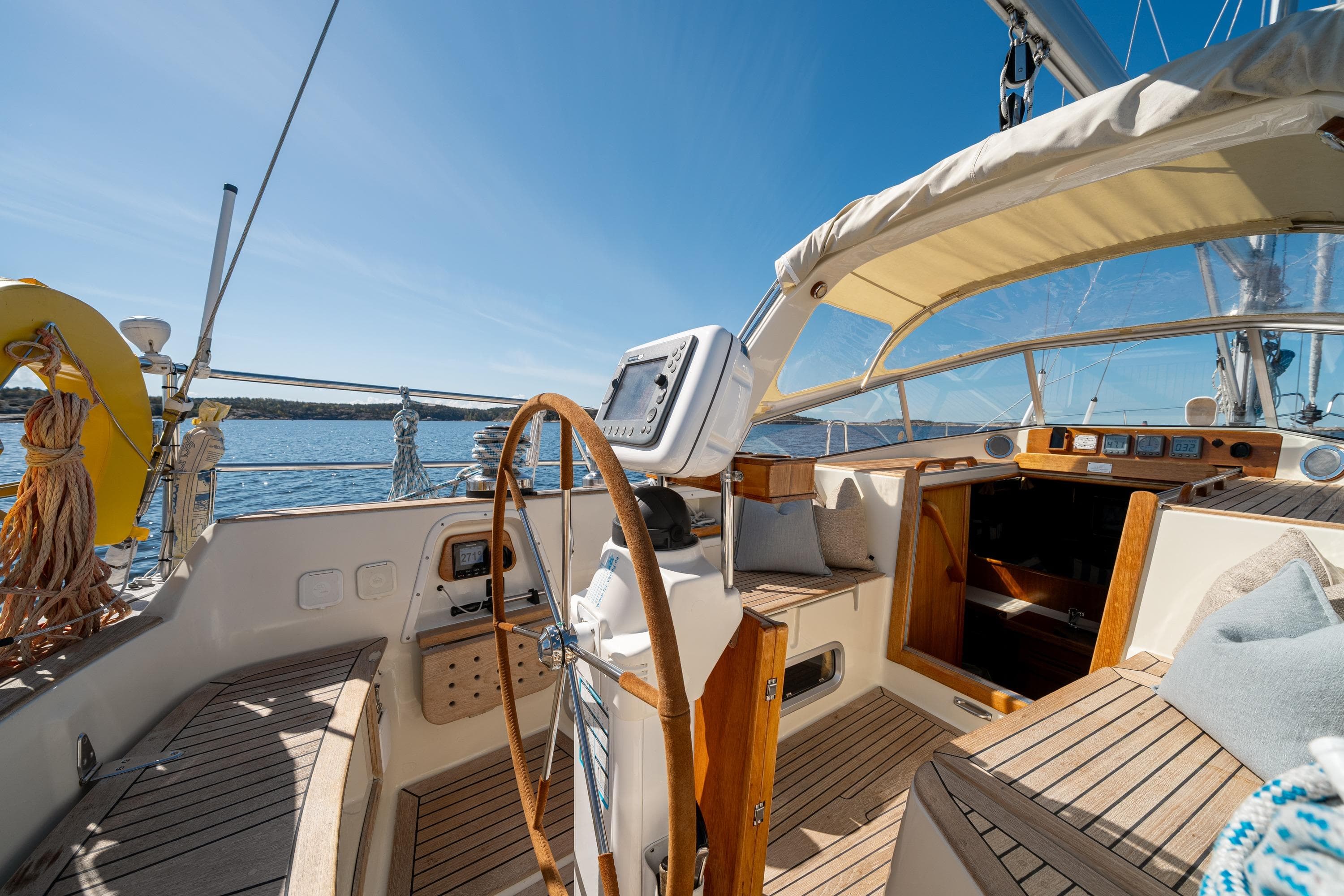 Cockpit of a 1997 Malo 42 sailboat with wooden accents and ocean view.