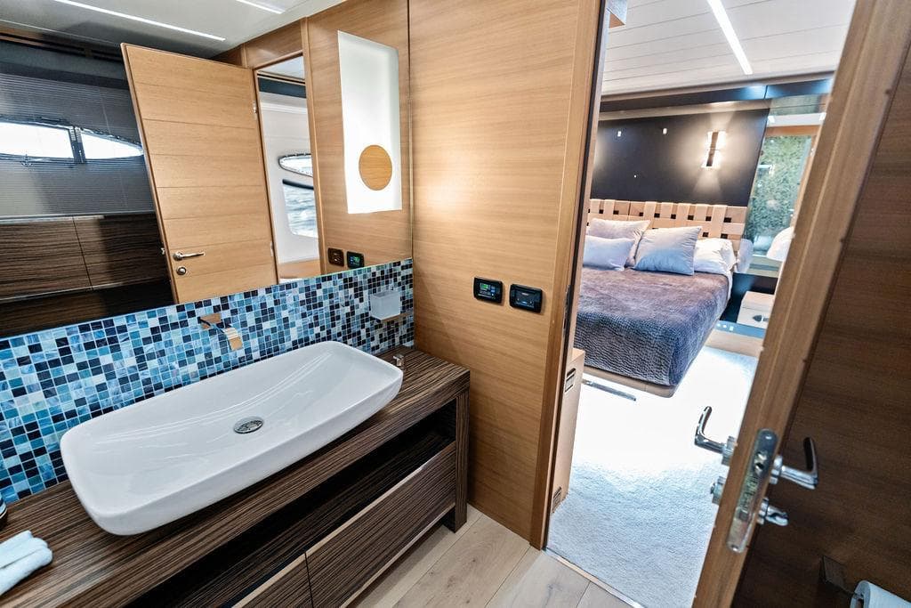 Luxurious bathroom and bedroom interior on a 2012 Pershing 92 yacht, featuring modern design elements.