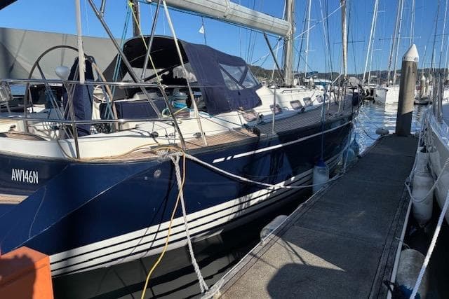 2001 X-Yachts X-482 sailboat docked at marina, featuring sleek blue hull and spacious deck.