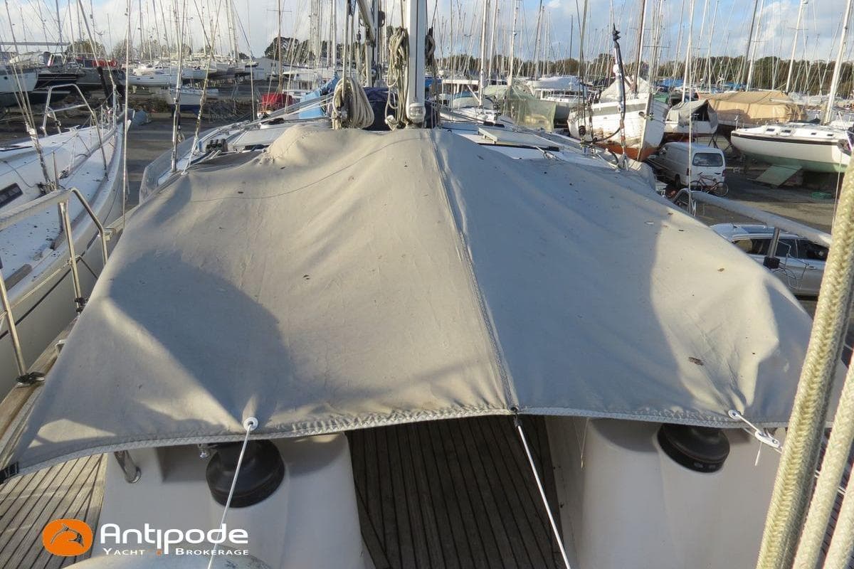 2006 Siltala Nauticat 331 yacht with deck cover in marina setting.