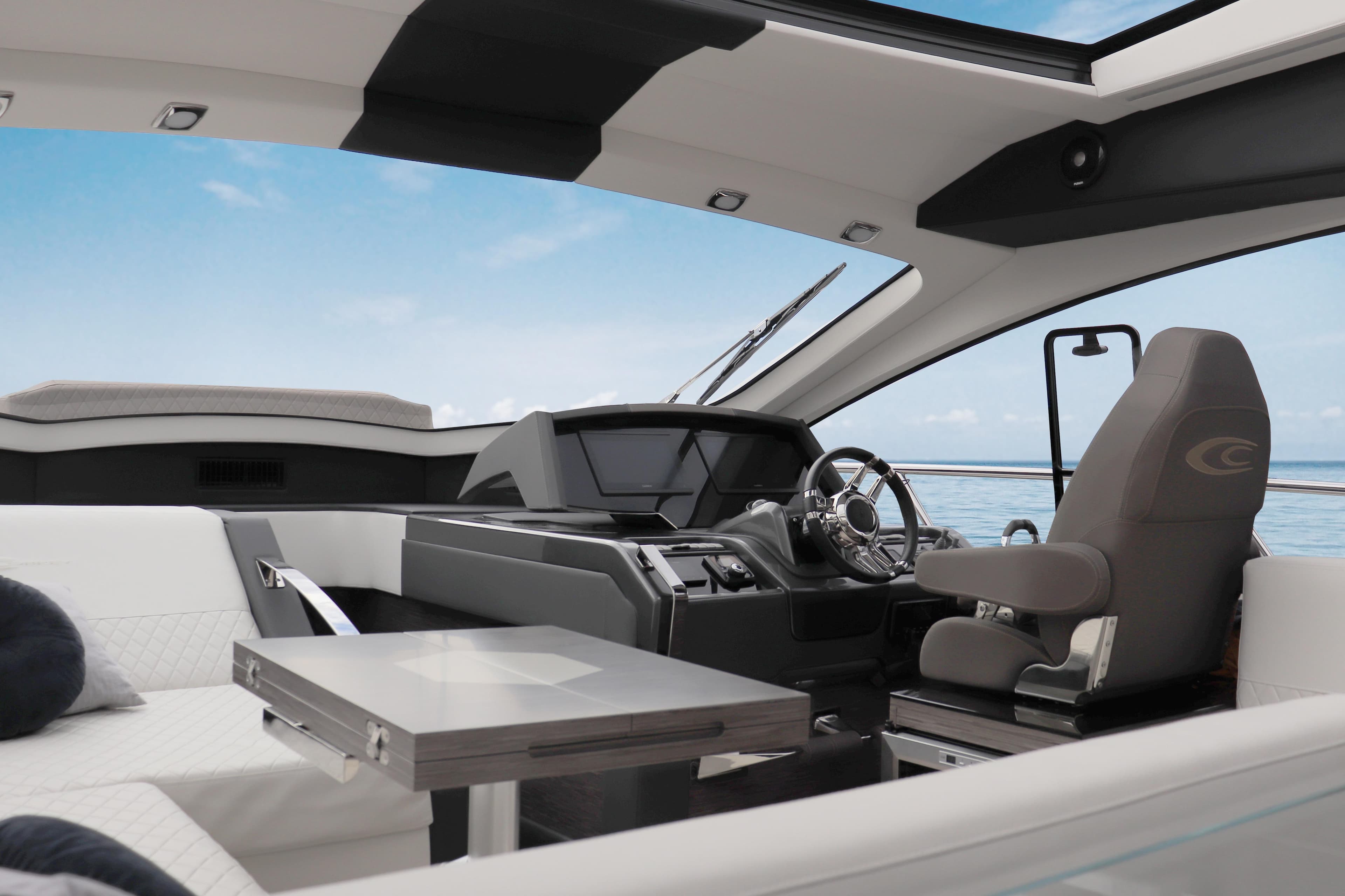 Interior of 2026 Cobrey 52 HT yacht, featuring modern helm and luxurious seating.