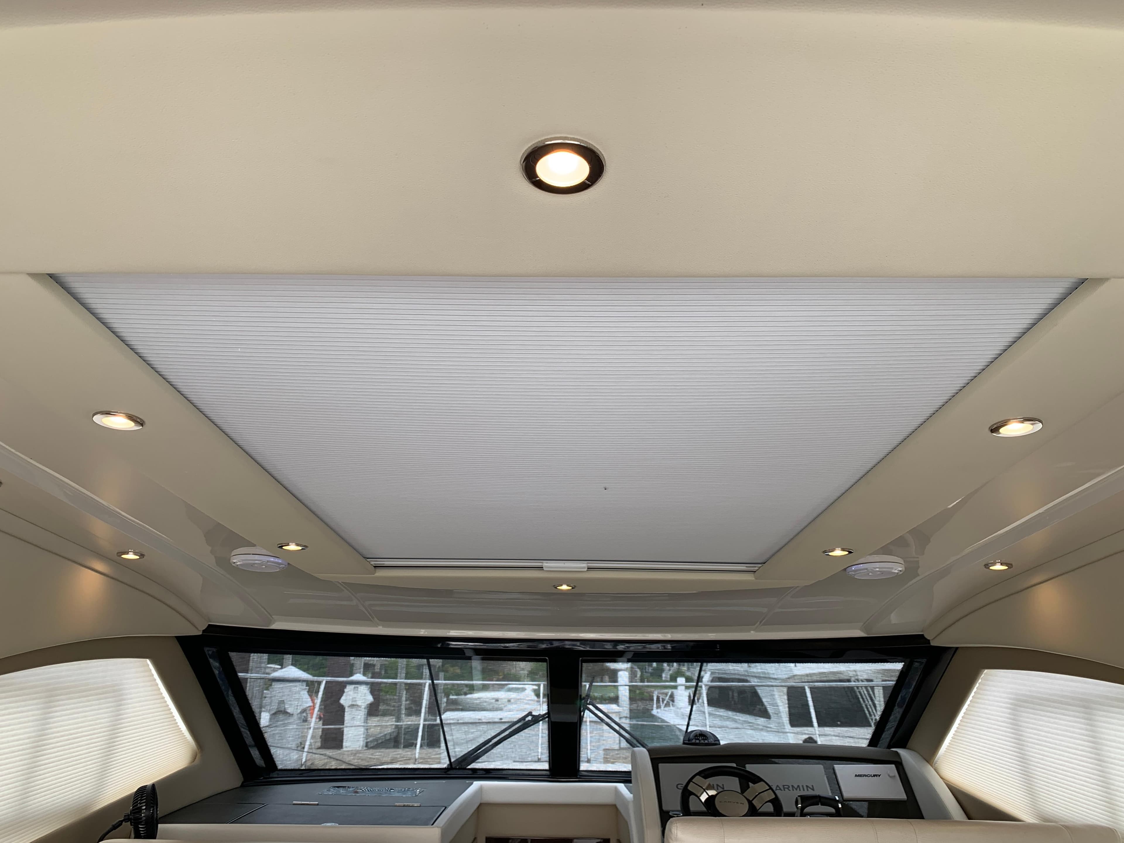 Interior view of 2020 Carver C37 Coupe yacht with sunroof and modern dashboard.