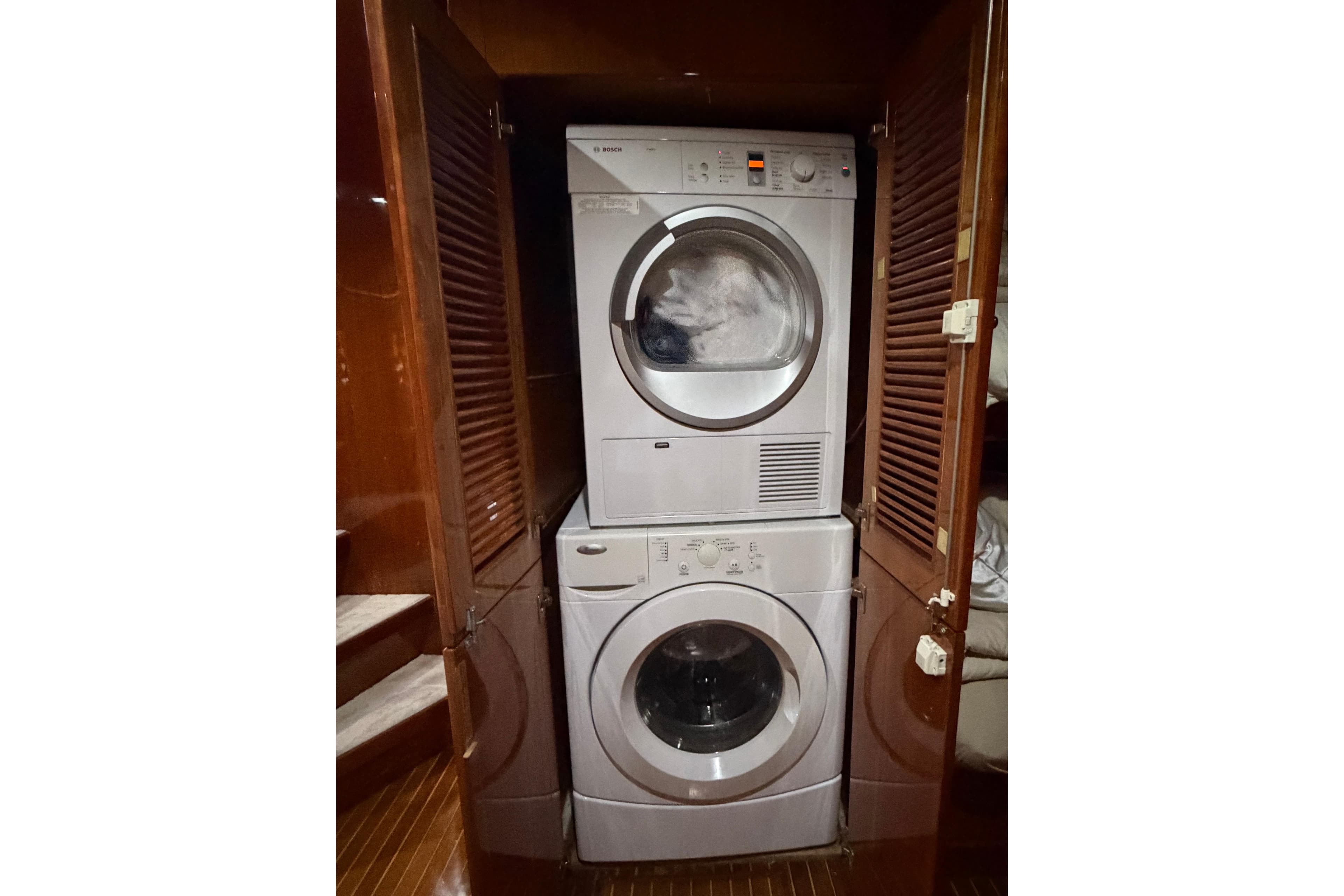 Stacked washer and dryer in wooden cabinet on Hargrave 94 yacht, 2001 model.