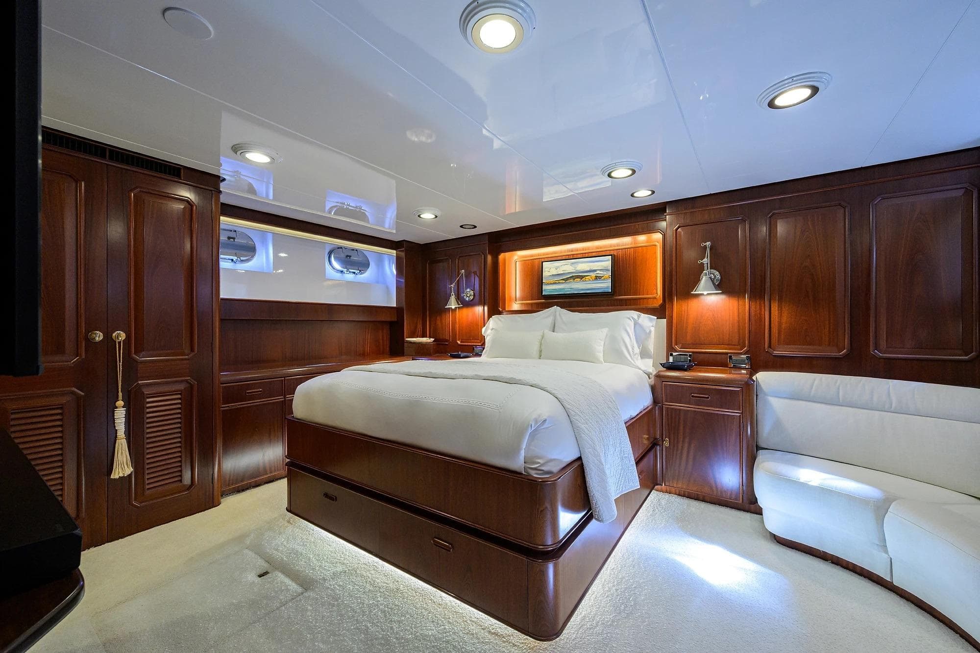 Luxurious cabin interior of 1986 Jongert 85 yacht with elegant wood paneling and plush bedding.