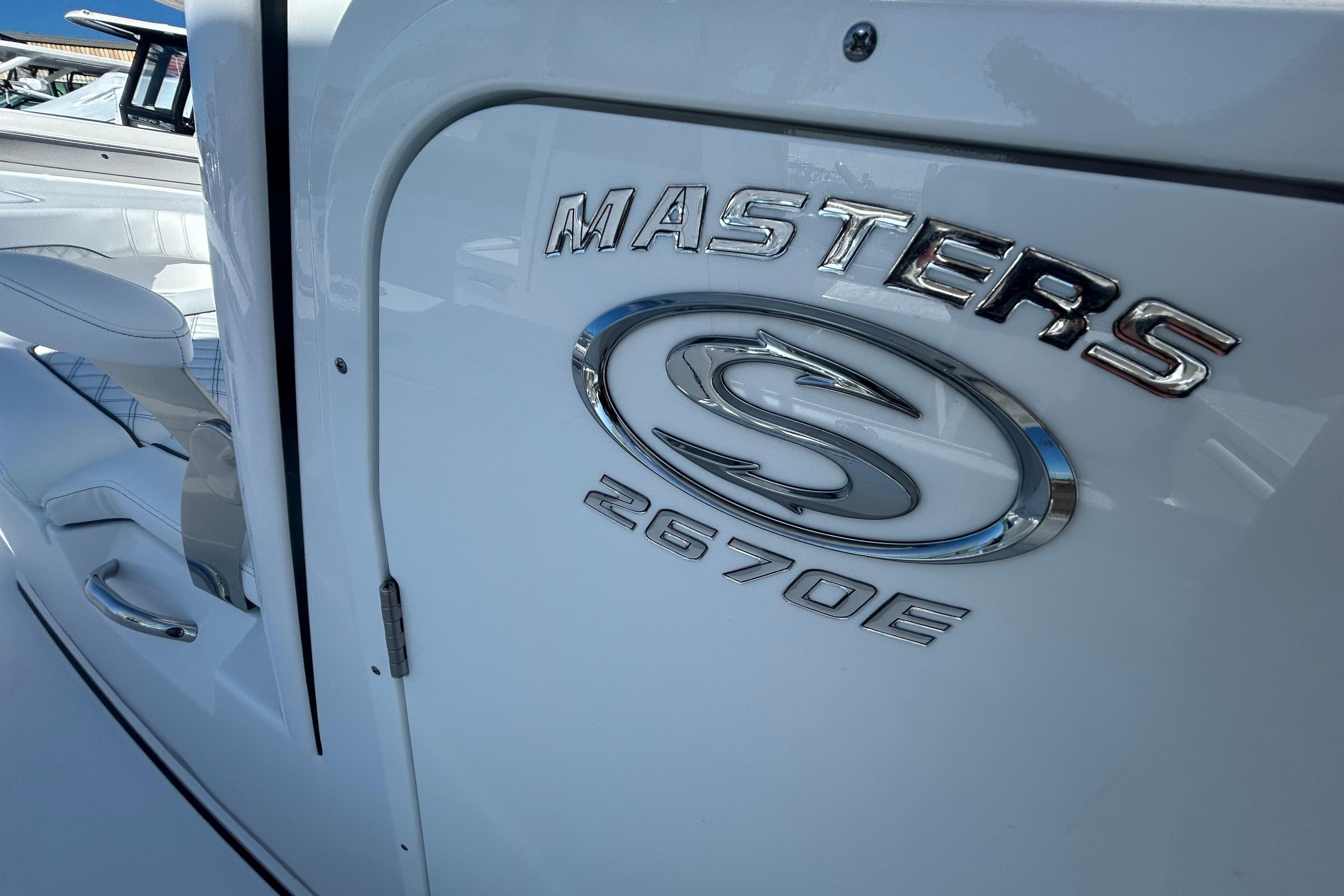 2026 Sportsman Masters 267OE Bay Boat, sleek design with chrome logo detailing.