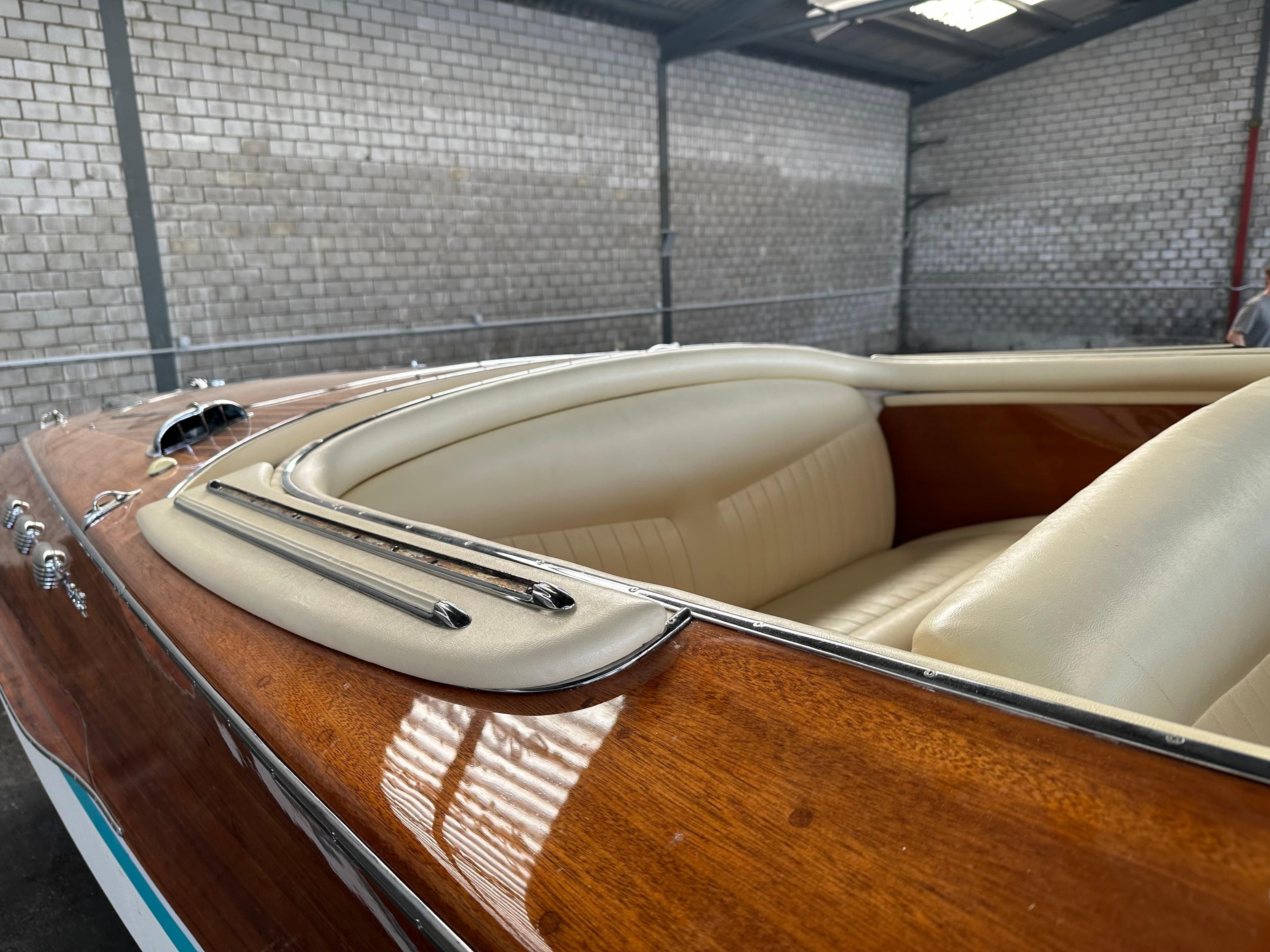 1966 Riva Super Ariston boat with polished wood finish and cream leather interior.