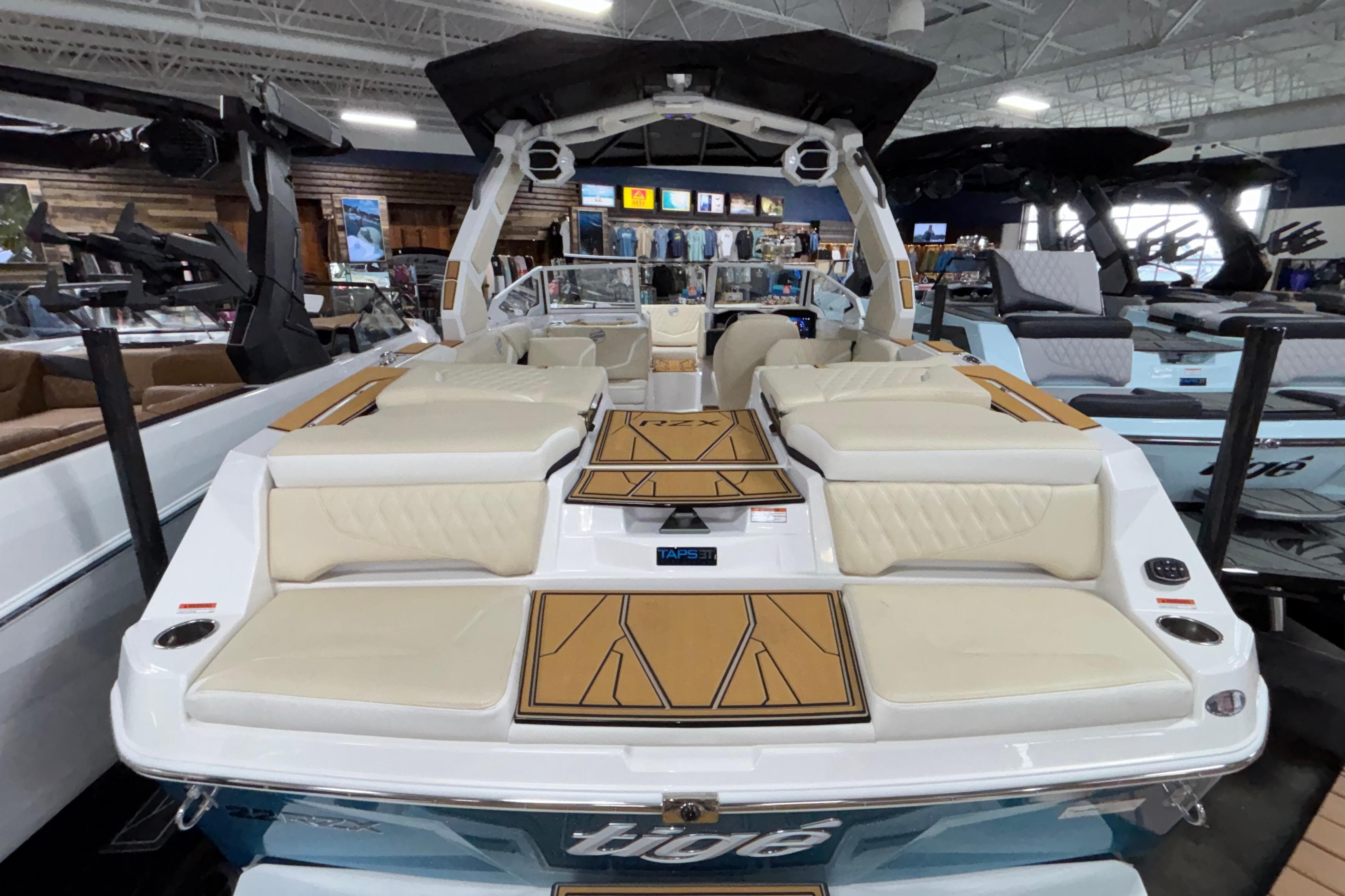 2026 Tigé 22RZX boat interior with luxurious seating and modern design in showroom.