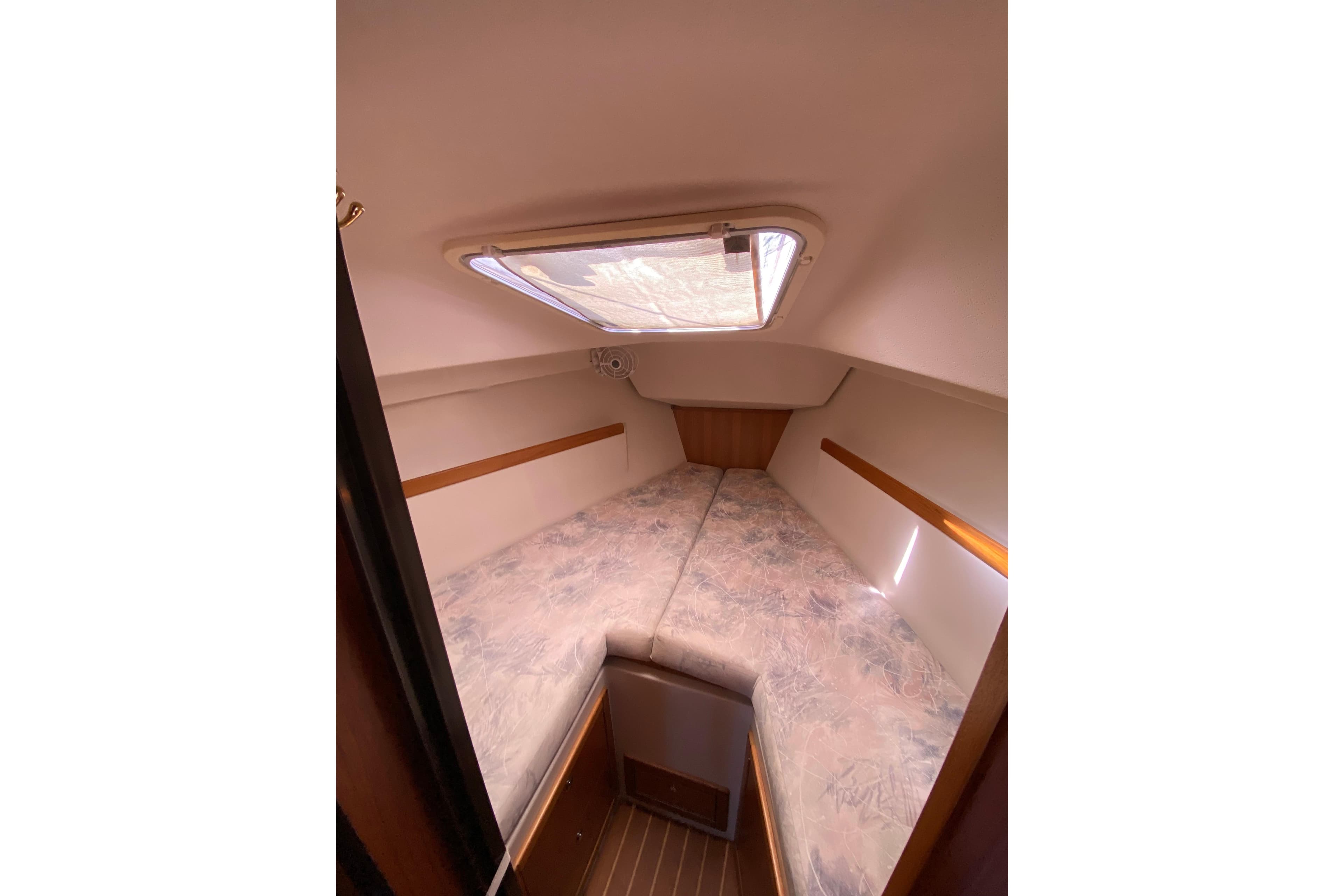 Cozy interior cabin of a 2006 Catalina 309 sailboat with a skylight.