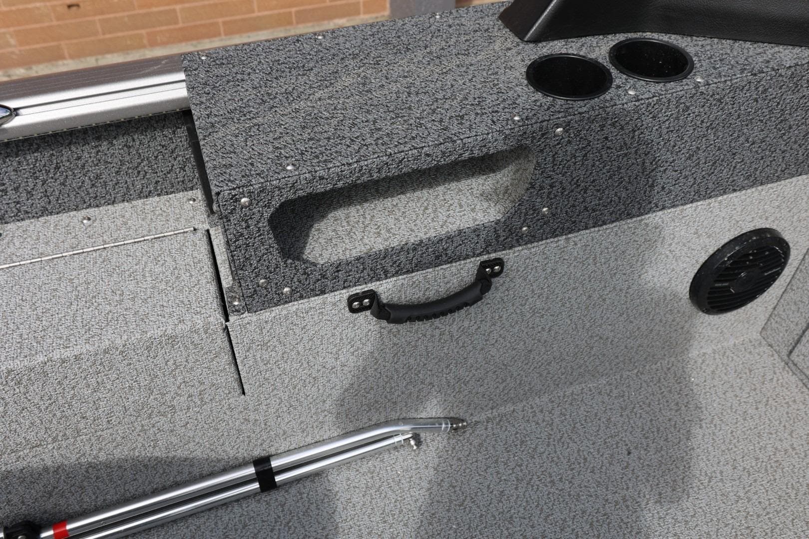 2026 Lund 1875 Impact XS Sport boat interior with storage, cup holders, and speaker.