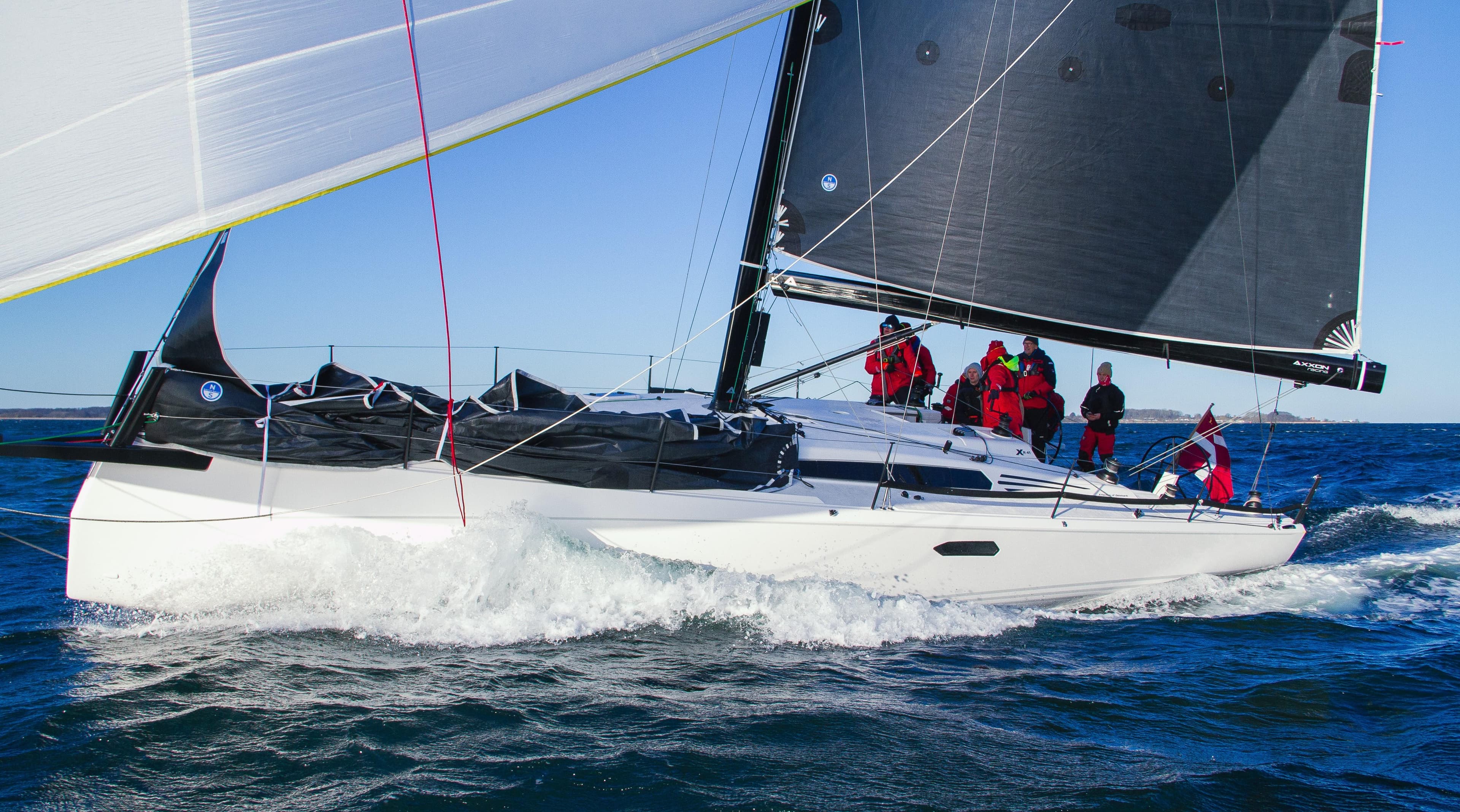 2025 X-Yachts XR 41 sailing on open water with crew onboard.