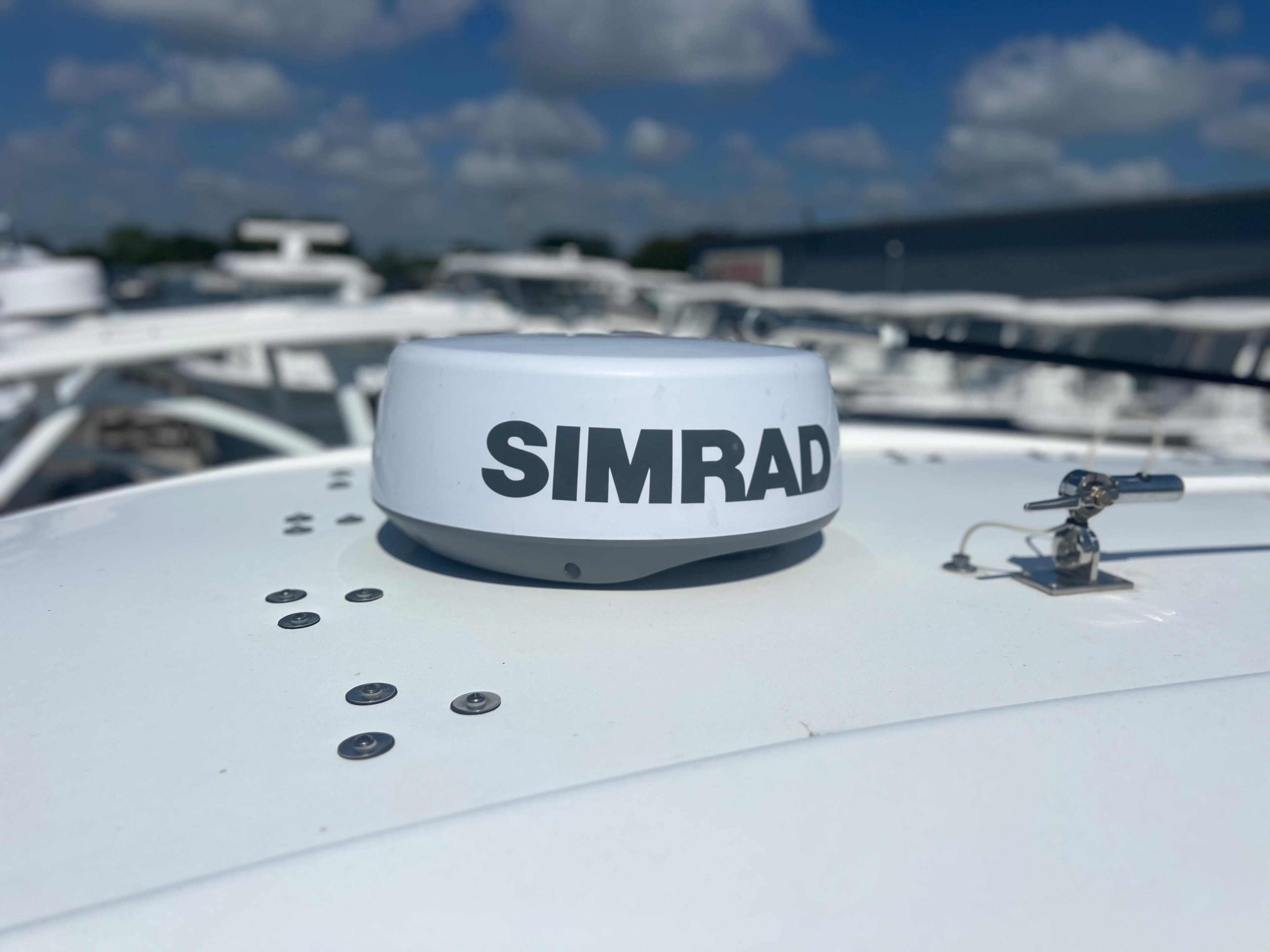 Simrad radar on 2022 Cape Horn 24 XS boat under a clear blue sky.