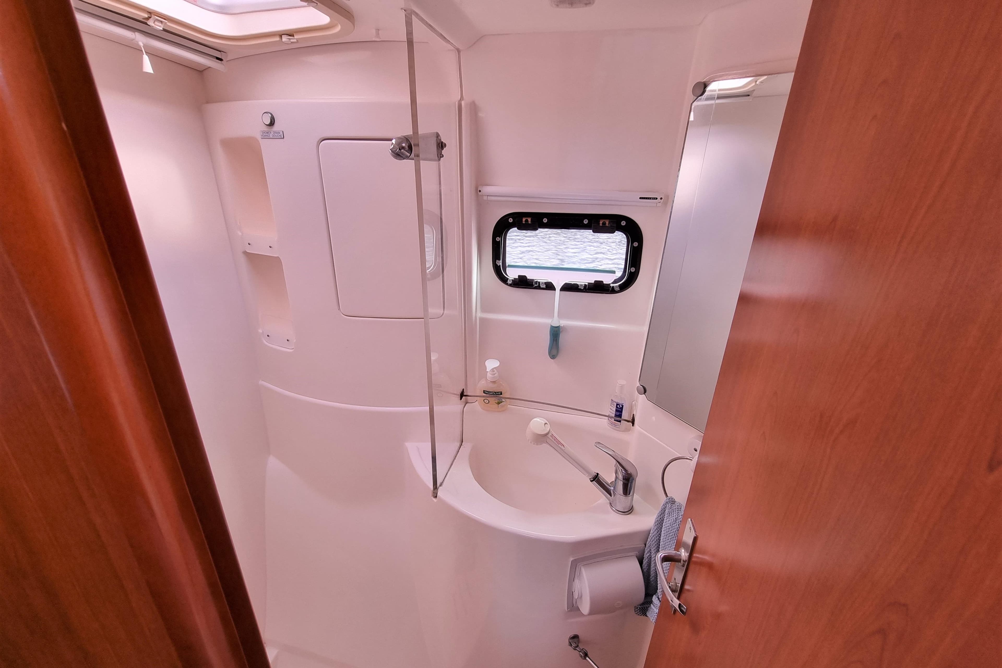 Bathroom interior of 2012 Leopard 39 Owners Version yacht, featuring sink and porthole.