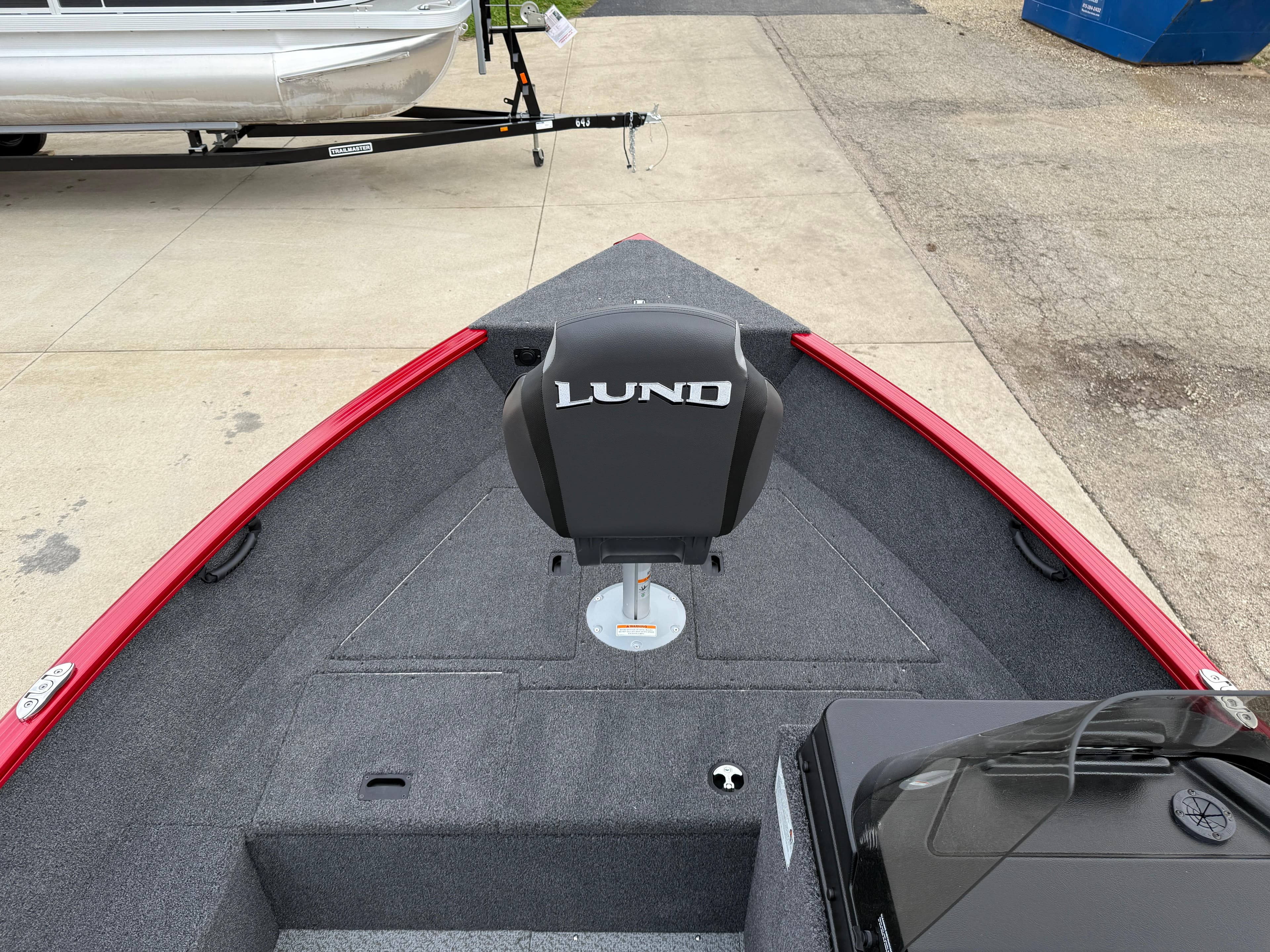 2025 Lund 1650 Rebel XL SS boat interior with red trim and branded seat.