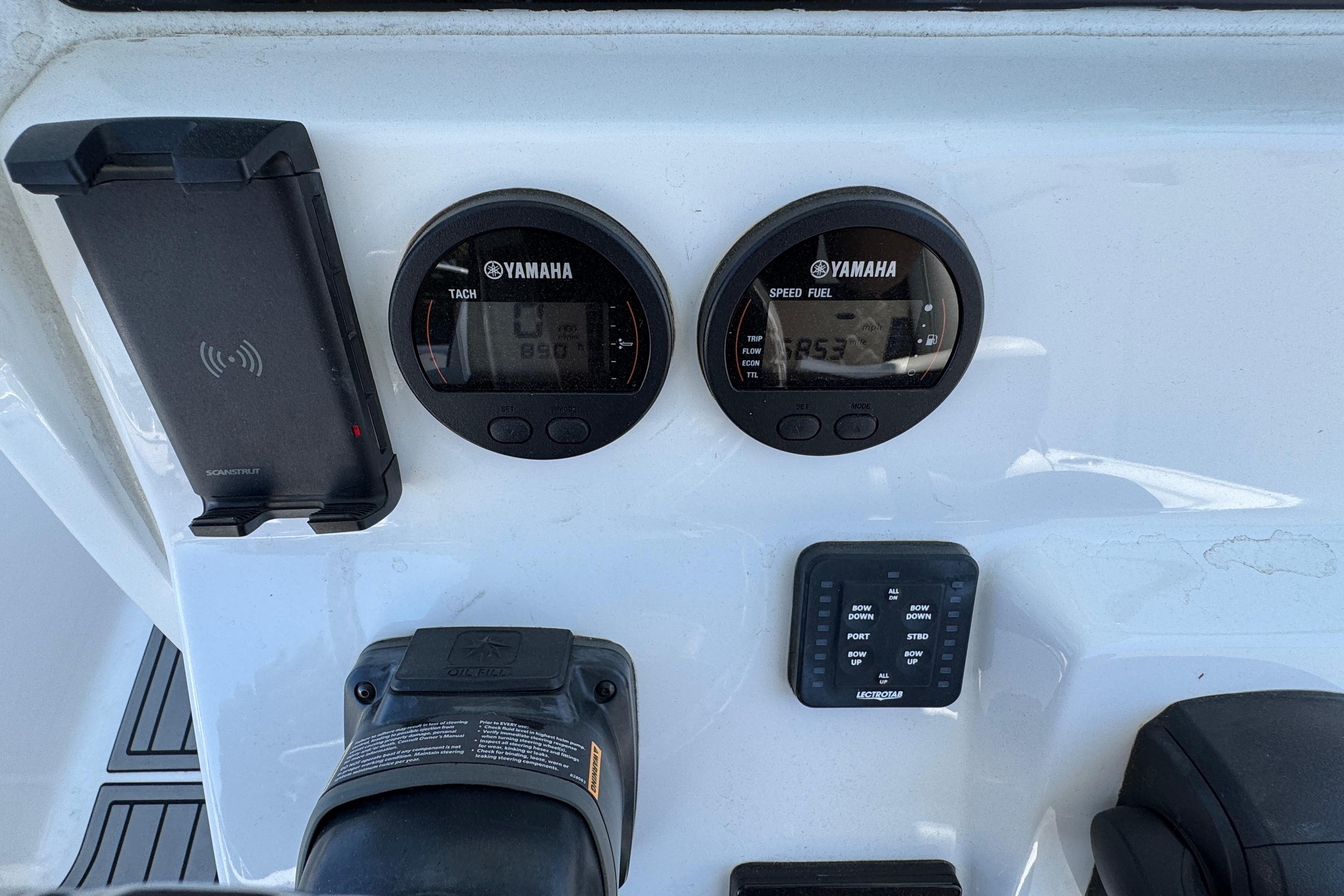Control panel of 2022 Tidewater 232 SS boat with Yamaha gauges and phone holder.