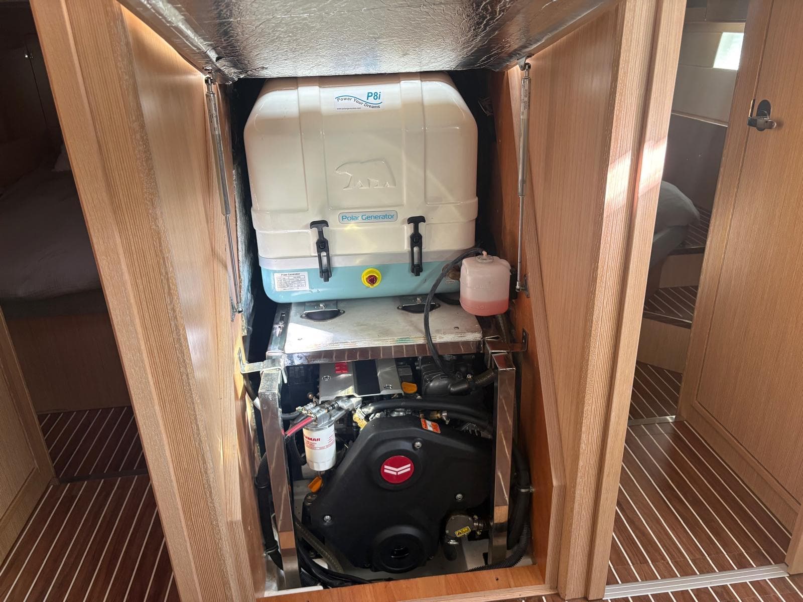 Engine compartment of a 2022 Bavaria C50 yacht, featuring a well-organized mechanical setup.
