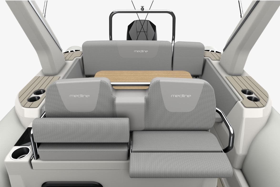 2026 Zodiac Medline 7.5 boat interior with gray seating and wooden table.