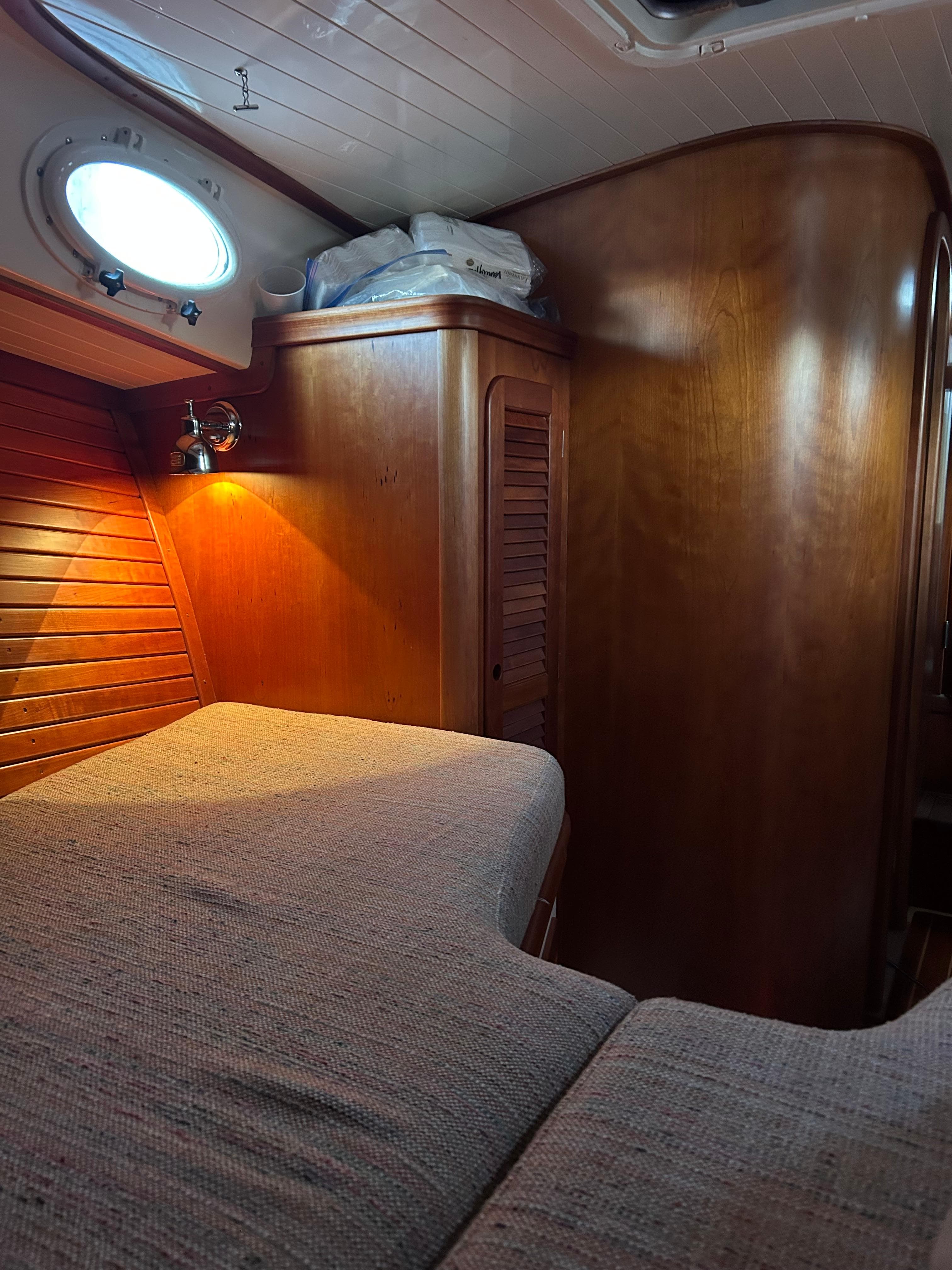 Cozy cabin interior of 2001 Hinckley Classic 36 Picnic Boat with wooden finish.