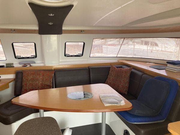 Interior of 2011 Fountaine Pajot Lipari 41 catamaran with cozy seating and table.