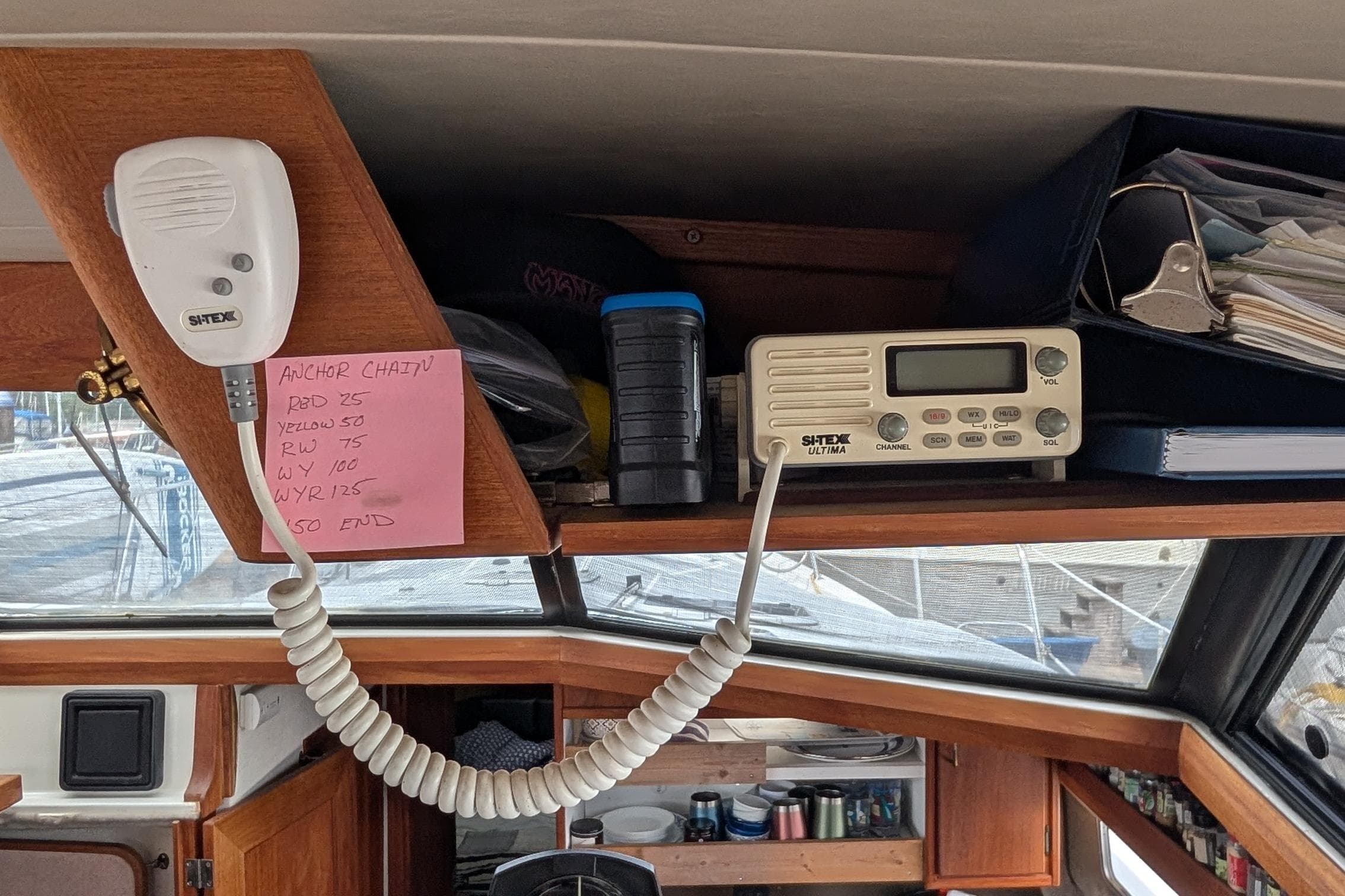 1990 Bayliner 3888 Motoryacht interior with radio, microphone, and navigation notes.