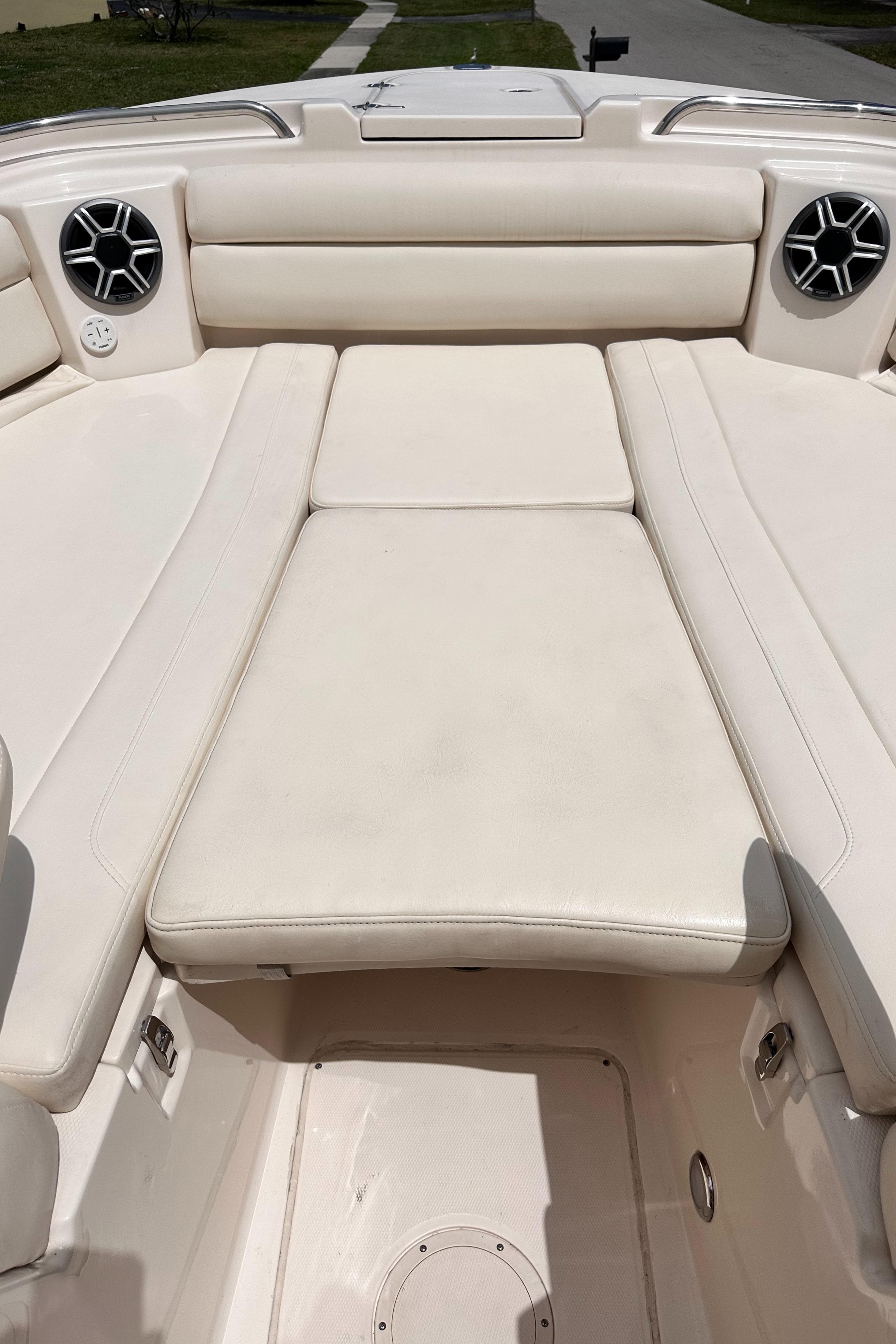 2019 Grady-White Freedom 325 boat interior with white cushioned seating and built-in speakers.