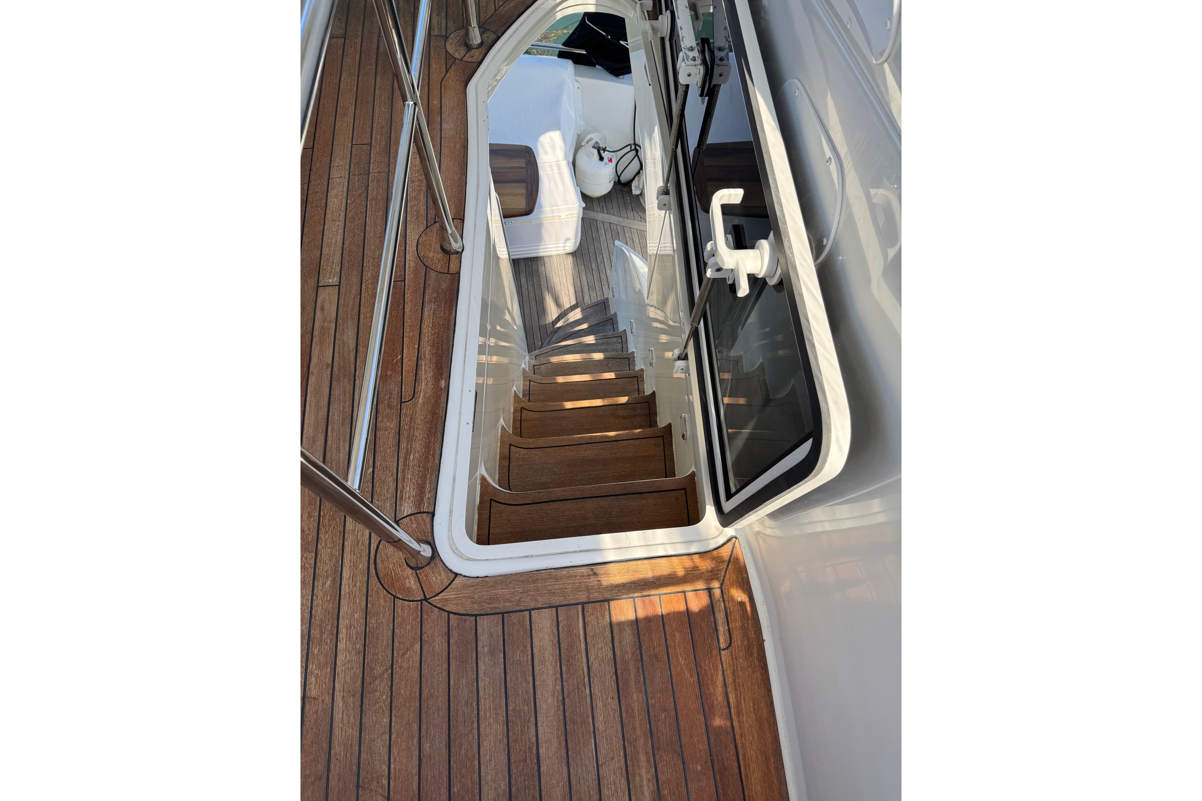 Staircase on 2006 Marquis 59 yacht with wooden deck and sleek design.