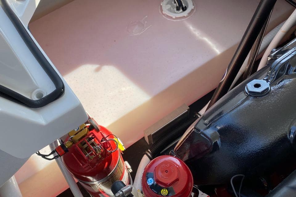 Engine compartment of a 2020 Cobalt R7 Surf boat with fire extinguisher.