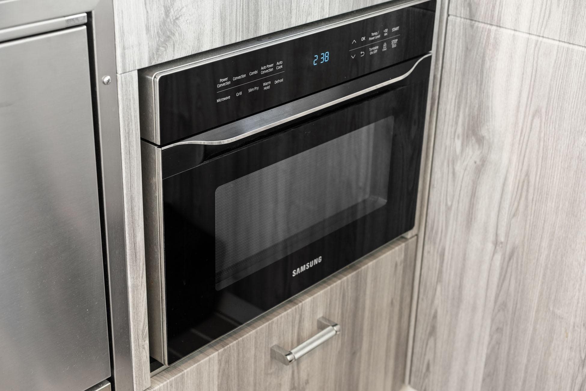 Built-in Samsung microwave in modern kitchen, part of 2025 Formula 500 Super Sport Crossover.