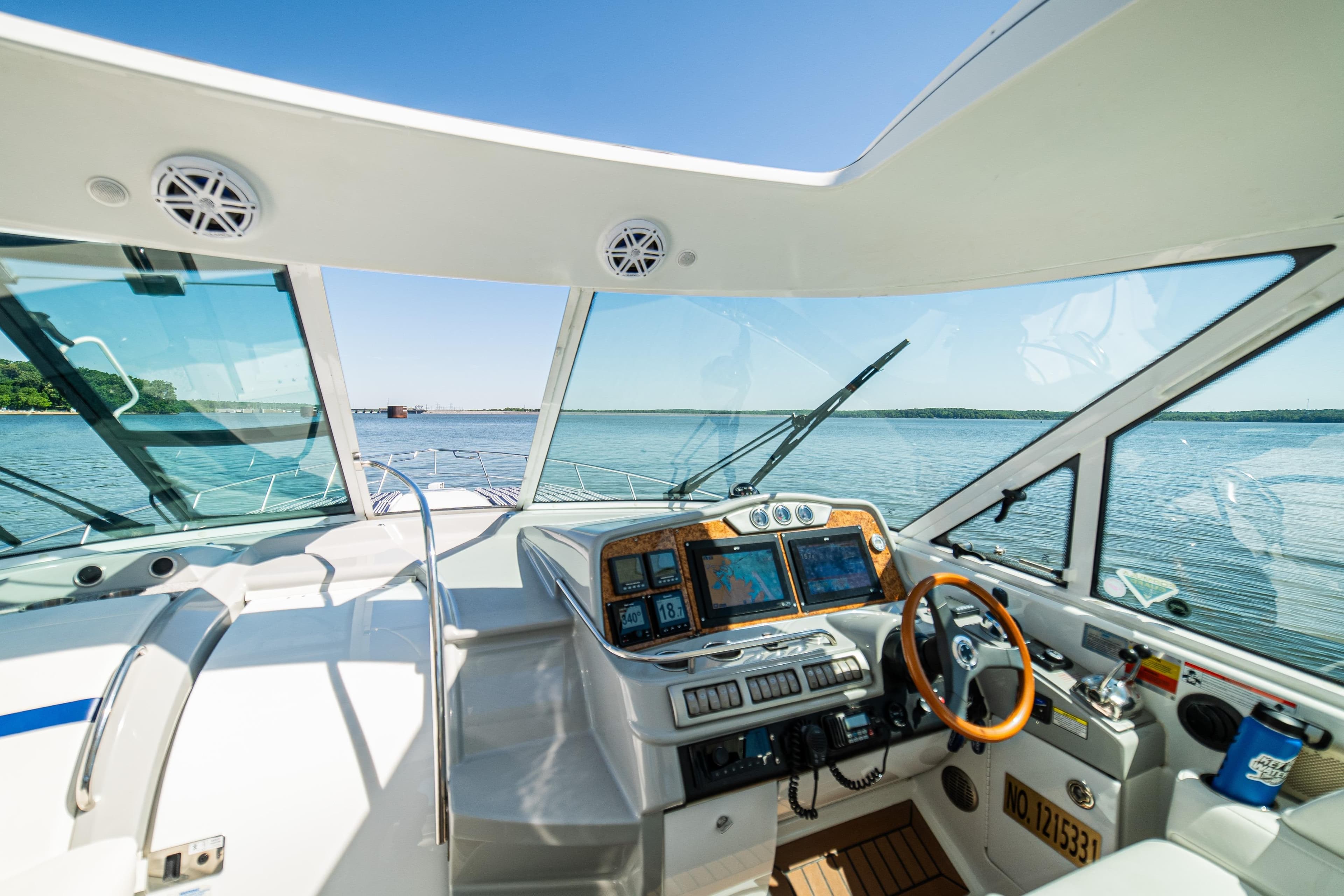 Interior view of 2008 Formula 45 Yacht cockpit with navigation screens and steering wheel.